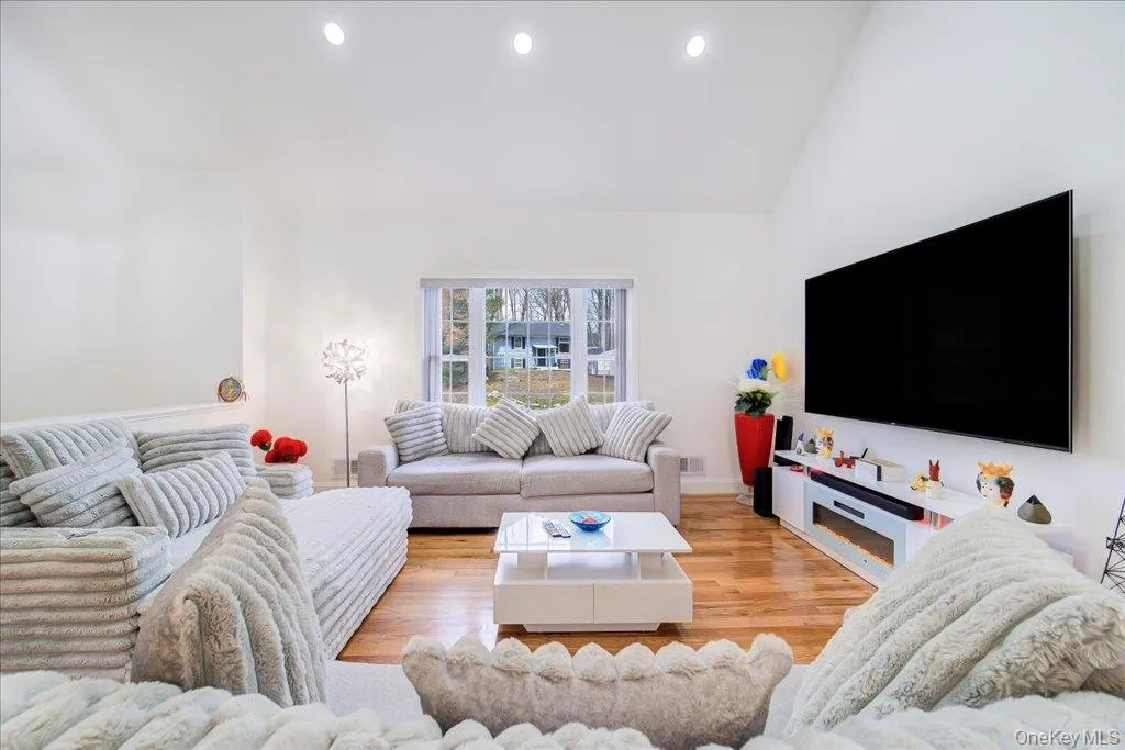 Spacious living area featuring high vaulted ceilings and recessed lighting Spacious living area featuring high vaulted ceilings and recessed lighting