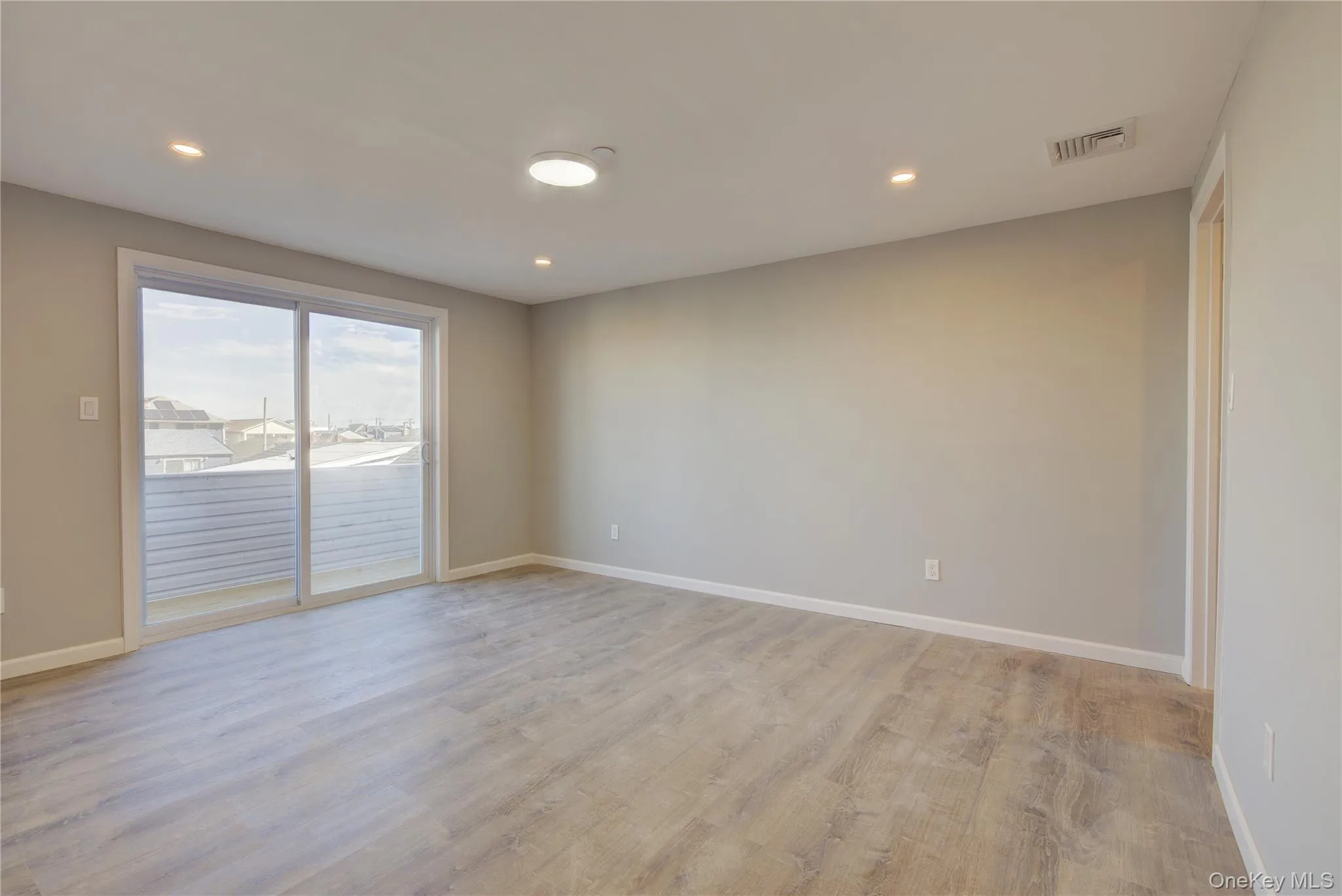 Spare room featuring recessed lighting, baseboards, and light wood-style flooring Spare room featuring recessed lighting, baseboards, and light wood-style flooring