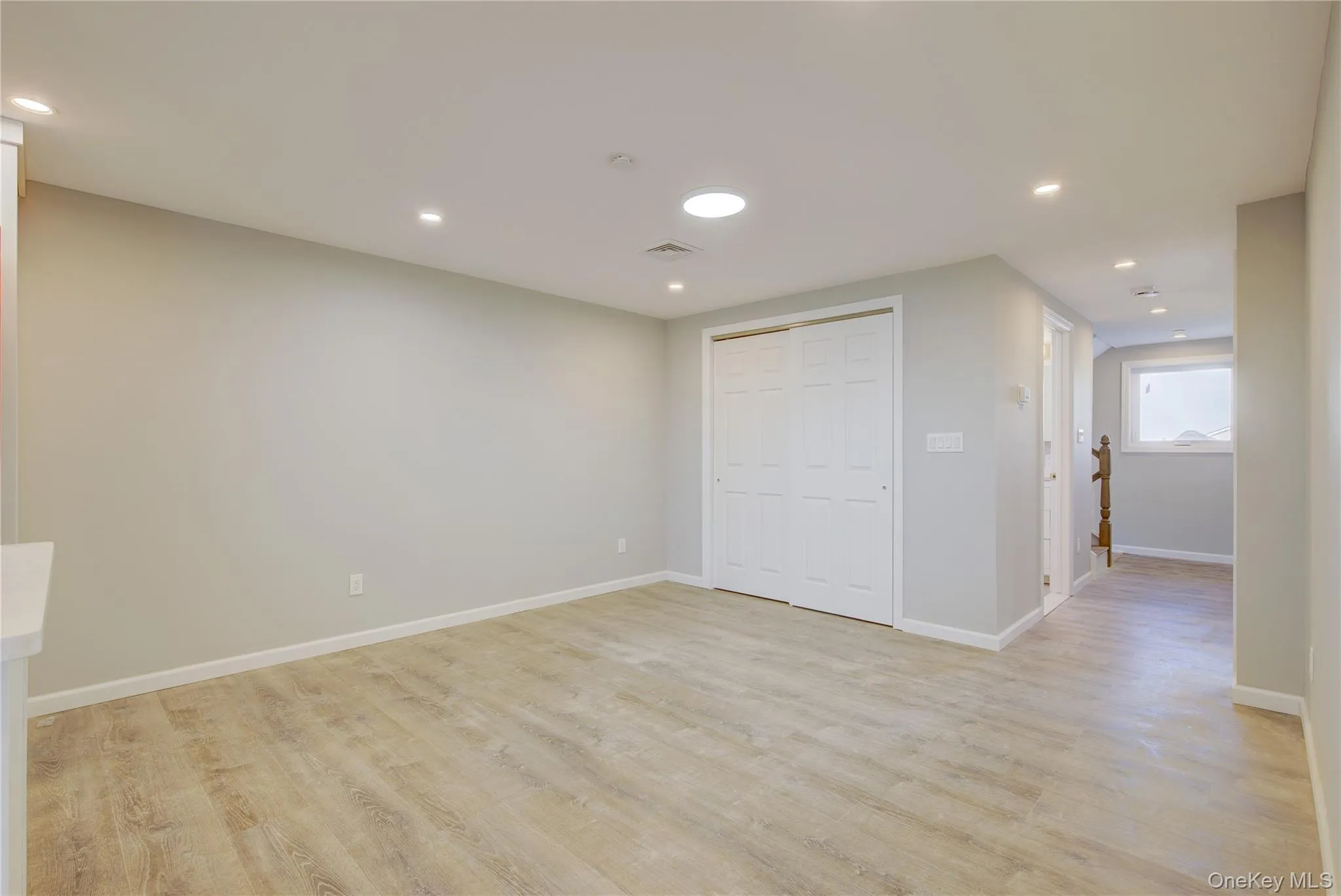 Spare room featuring light wood finished floors, recessed lighting, and baseboards Spare room featuring light wood finished floors, recessed lighting, and baseboards