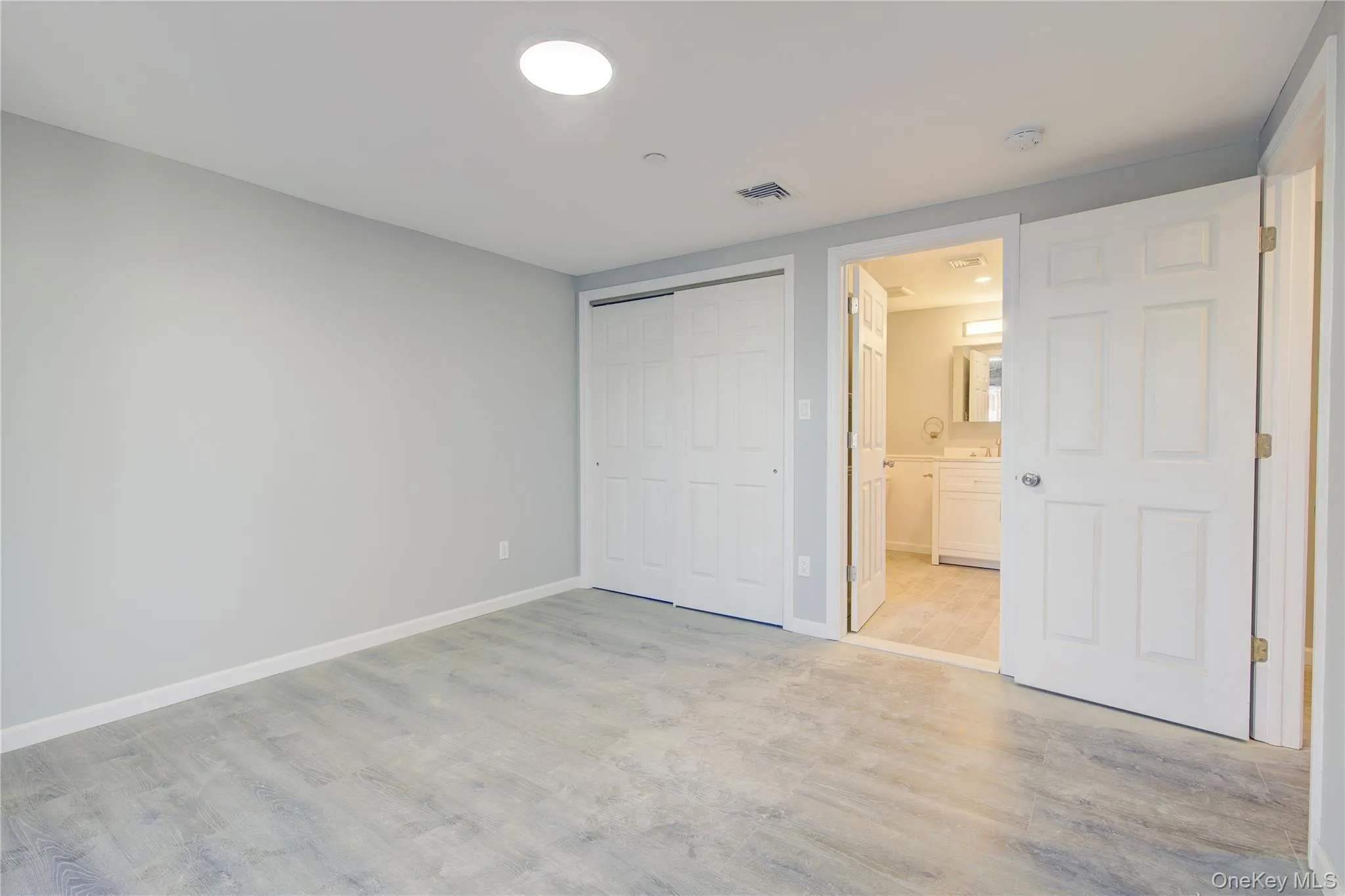 Unfurnished bedroom featuring visible vents, baseboards, a closet, and light wood-style flooring Unfurnished bedroom featuring visible vents, baseboards, a closet, and light wood-style flooring