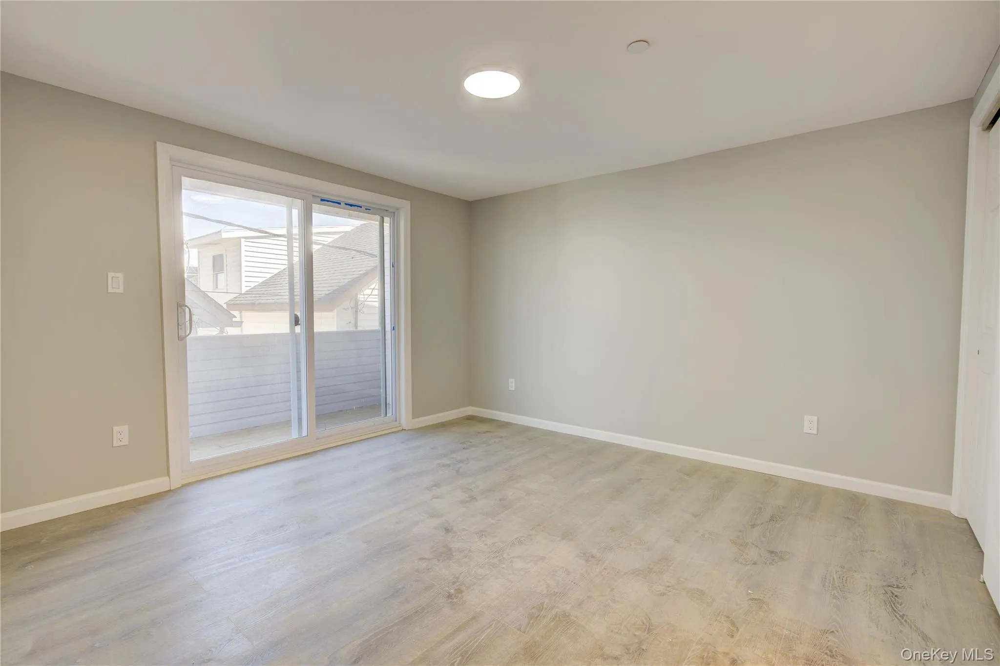 Unfurnished room with light wood-type flooring and baseboards Unfurnished room with light wood-type flooring and baseboards