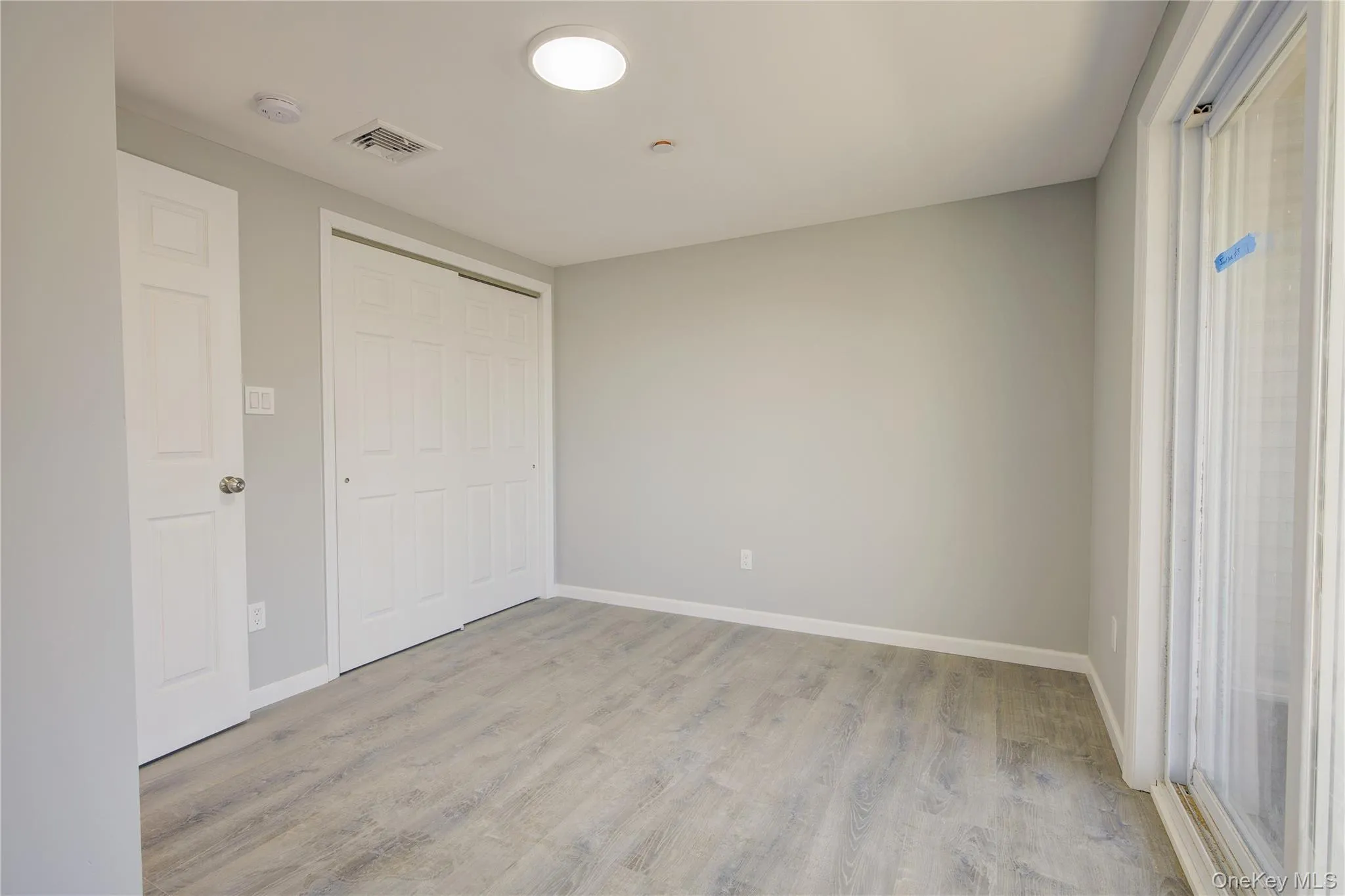 Unfurnished room featuring visible vents, baseboards, and light wood-style floors Unfurnished room featuring visible vents, baseboards, and light wood-style floors