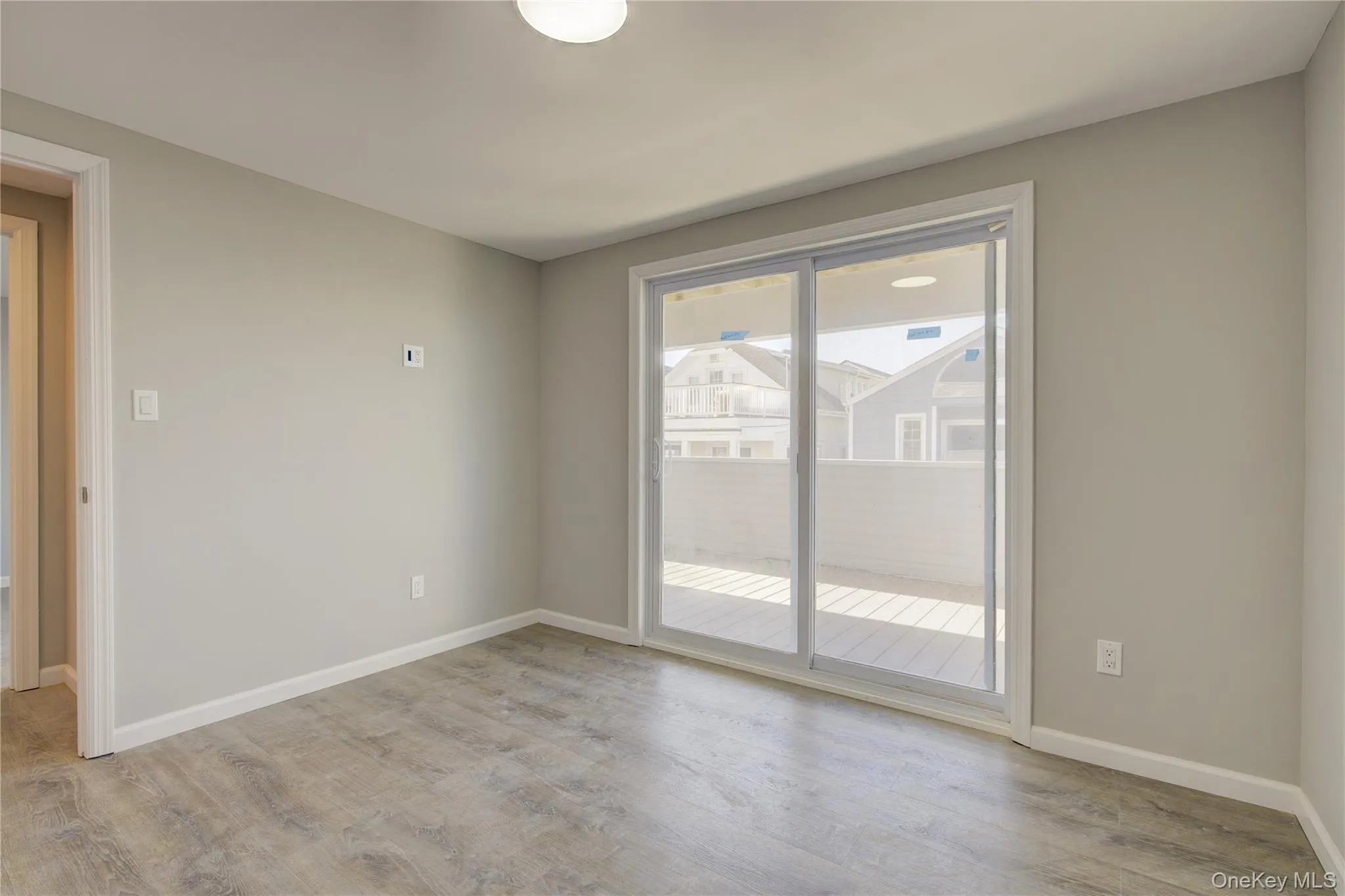 Spare room with light wood-type flooring and baseboards Spare room with light wood-type flooring and baseboards