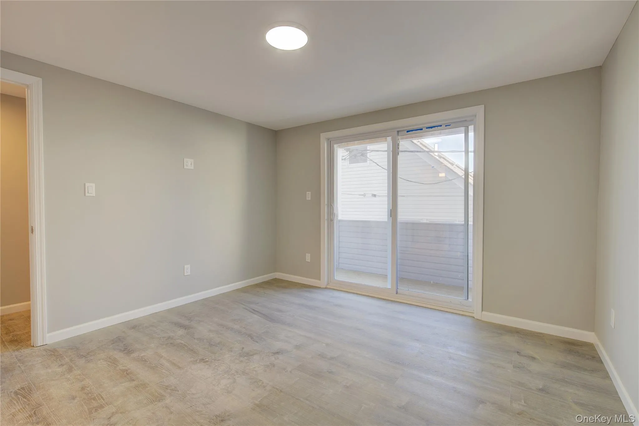 Spare room with baseboards and light wood-style flooring Spare room with baseboards and light wood-style flooring