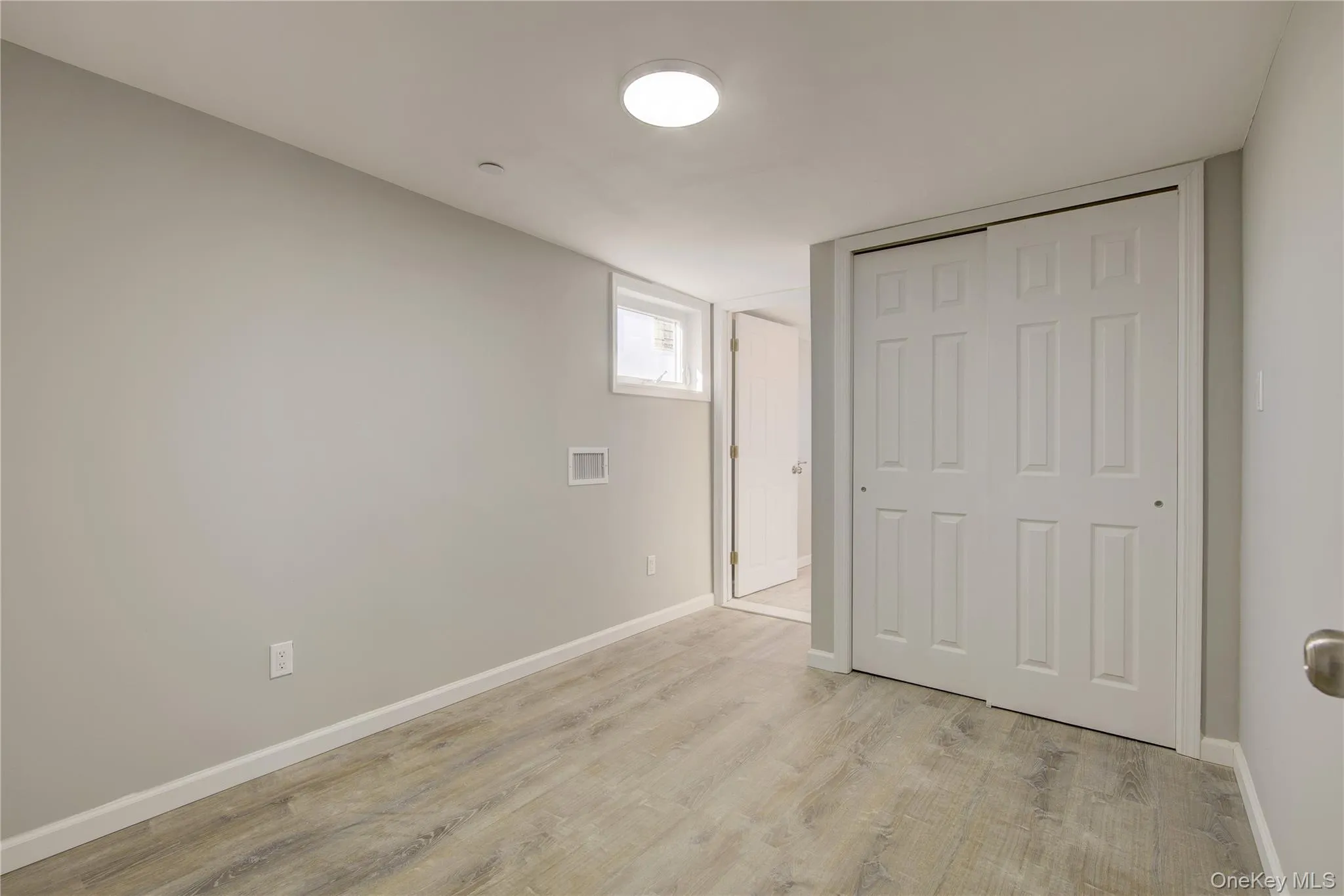Unfurnished bedroom with visible vents, baseboards, a closet, and light wood finished floors Unfurnished bedroom with visible vents, baseboards, a closet, and light wood finished floors