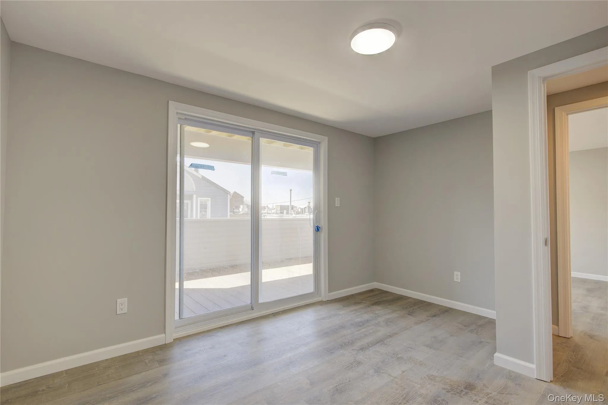 Unfurnished room with light wood-type flooring and baseboards Unfurnished room with light wood-type flooring and baseboards