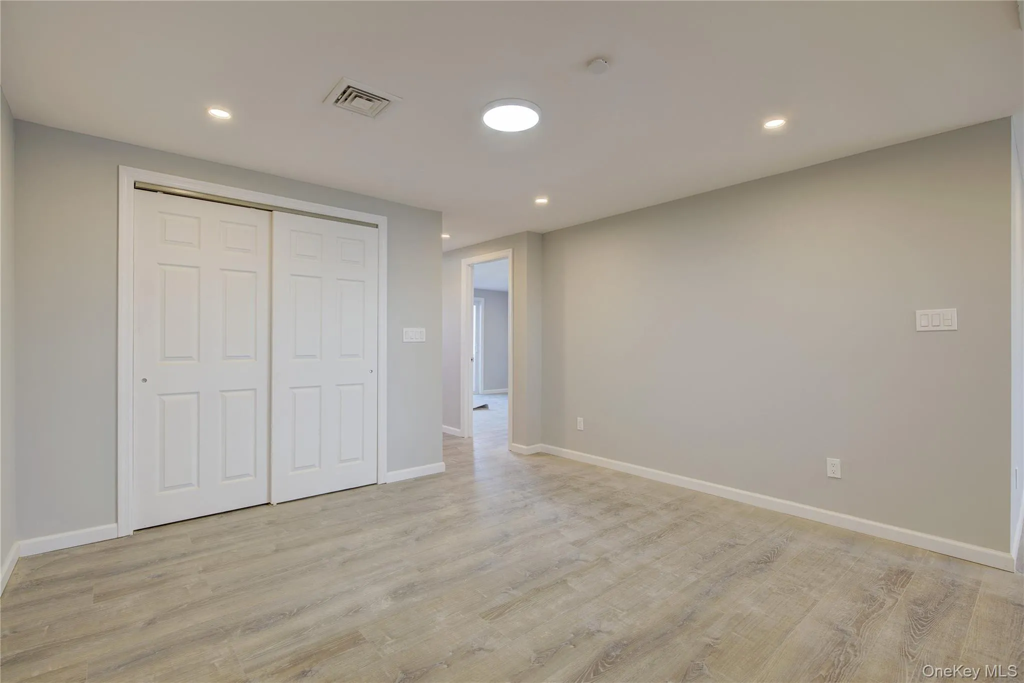 Unfurnished bedroom featuring recessed lighting, visible vents, baseboards, and light wood-style floors Unfurnished bedroom featuring recessed lighting, visible vents, baseboards, and light wood-style floors