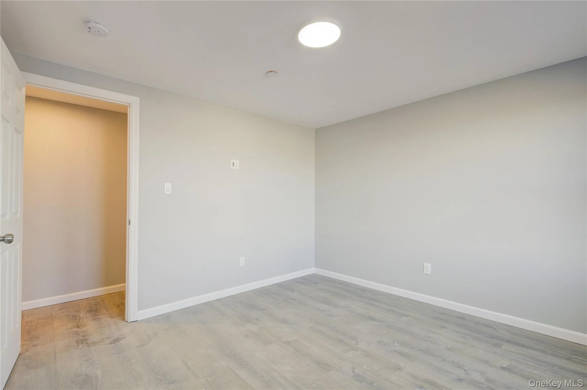 Unfurnished room featuring baseboards and light wood finished floors Unfurnished room featuring baseboards and light wood finished floors