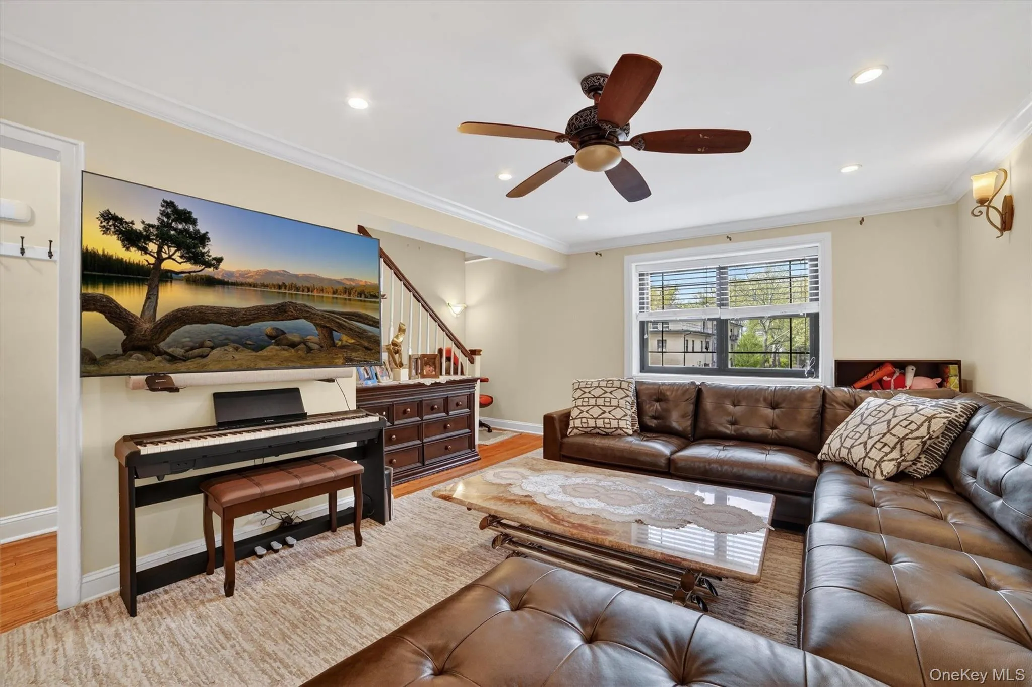 Large living room looking towards the staircase to the upstairs with a picturesque window Large living room looking towards the staircase to the upstairs with a picturesque window