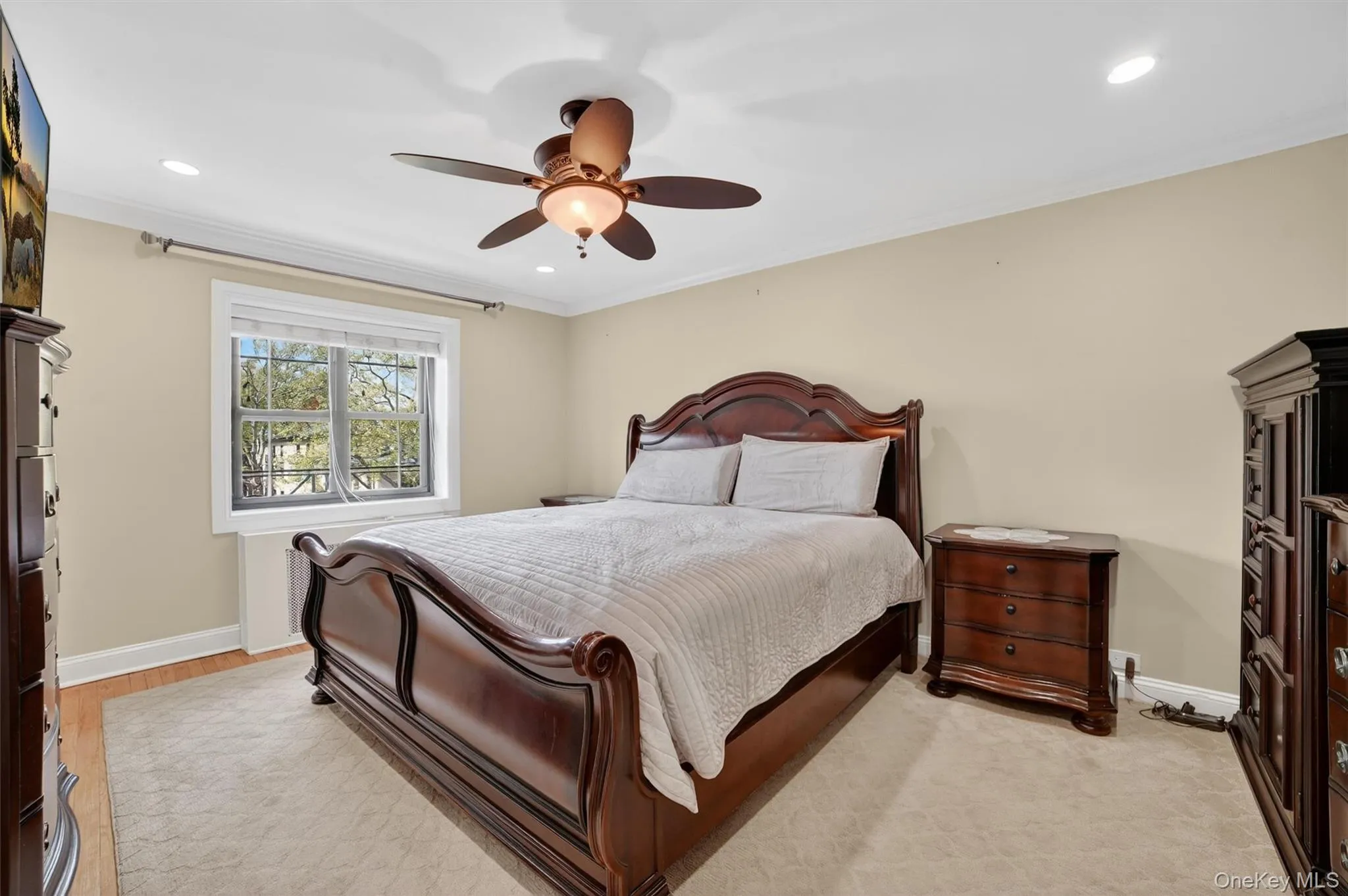 Primary bedroom with ceiling fan and sun filled windows Primary bedroom with ceiling fan and sun filled windows