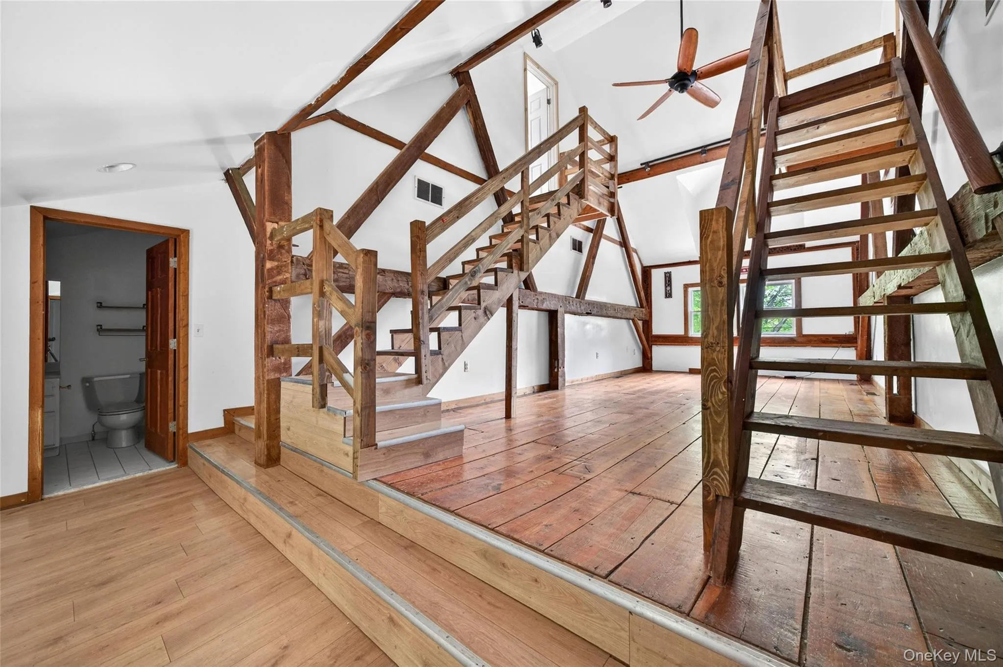 Exposed timber framing and wood-finish flooring define this multi-level interior Exposed timber framing and wood-finish flooring define this multi-level interior