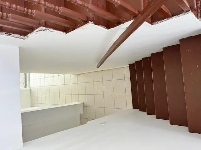 Staircase with wood treads and balusters, featuring a wood handrail Staircase with wood treads and balusters, featuring a wood handrail