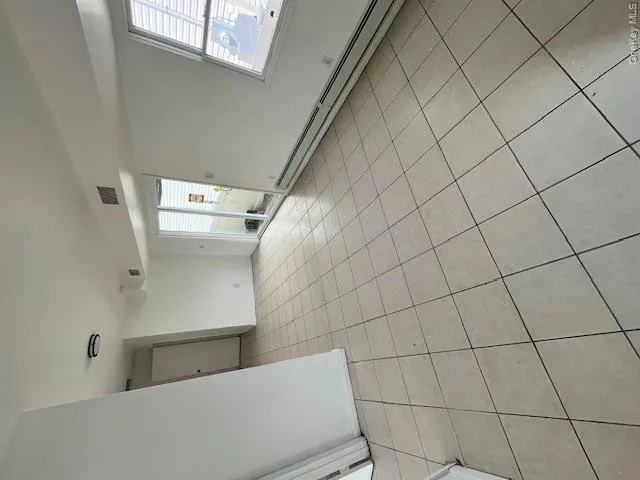 Bright interior with light-toned square tile flooring Bright interior with light-toned square tile flooring