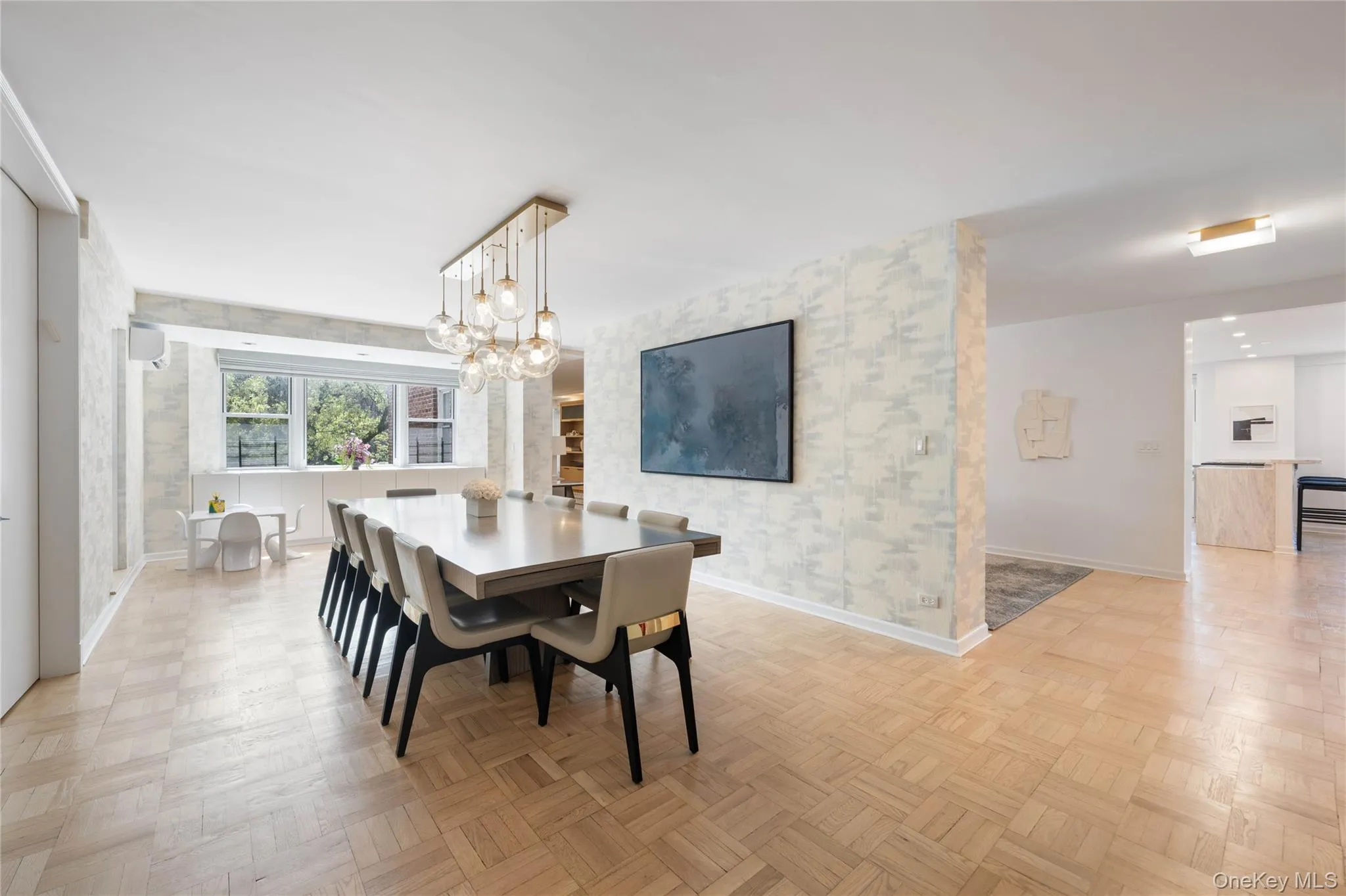 Spacious dining area featuring parquet flooring and a multi-globe chandelier Spacious dining area featuring parquet flooring and a multi-globe chandelier