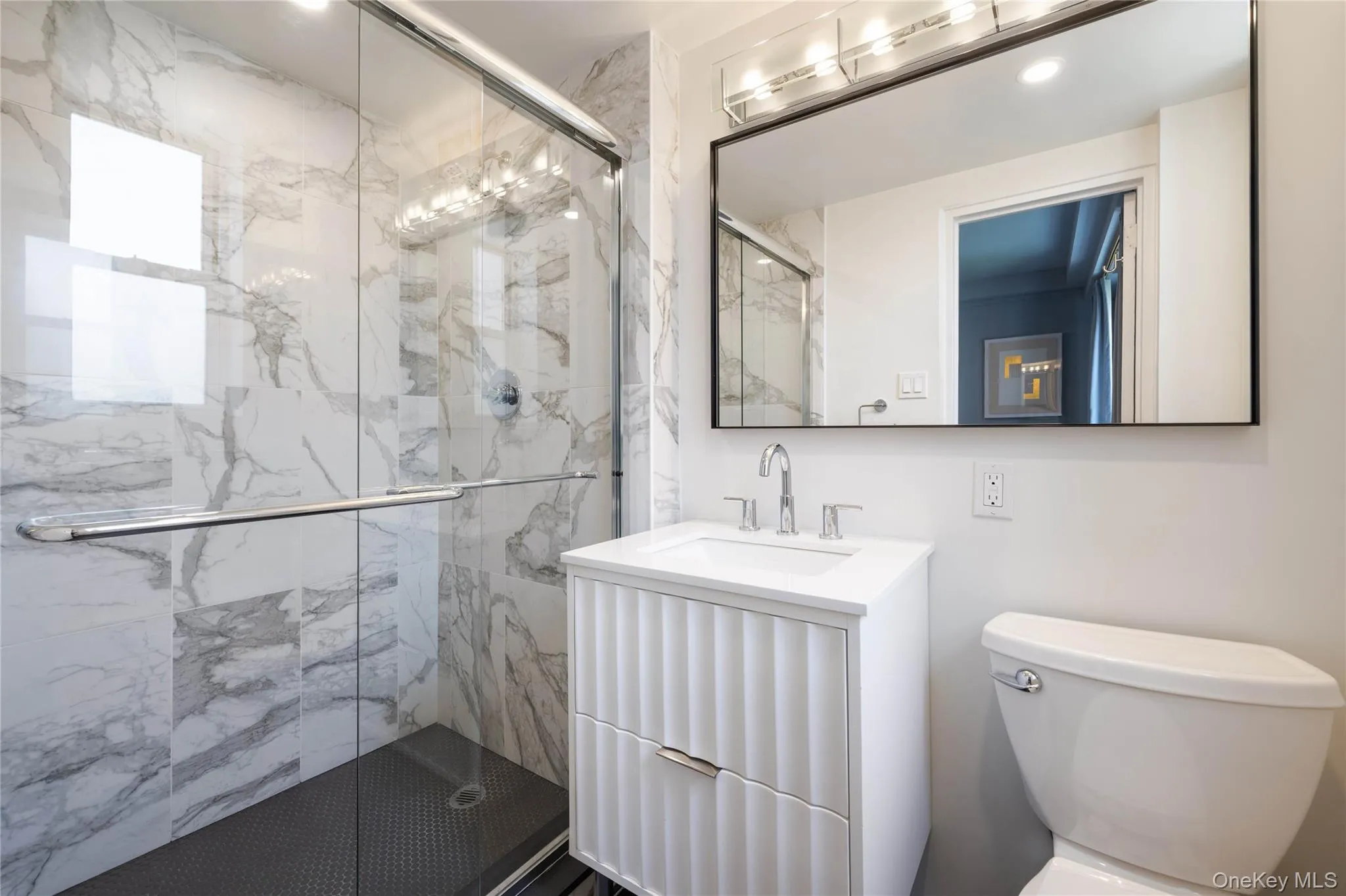 Bathroom featuring a glass-enclosed shower. Bathroom featuring a glass-enclosed shower.