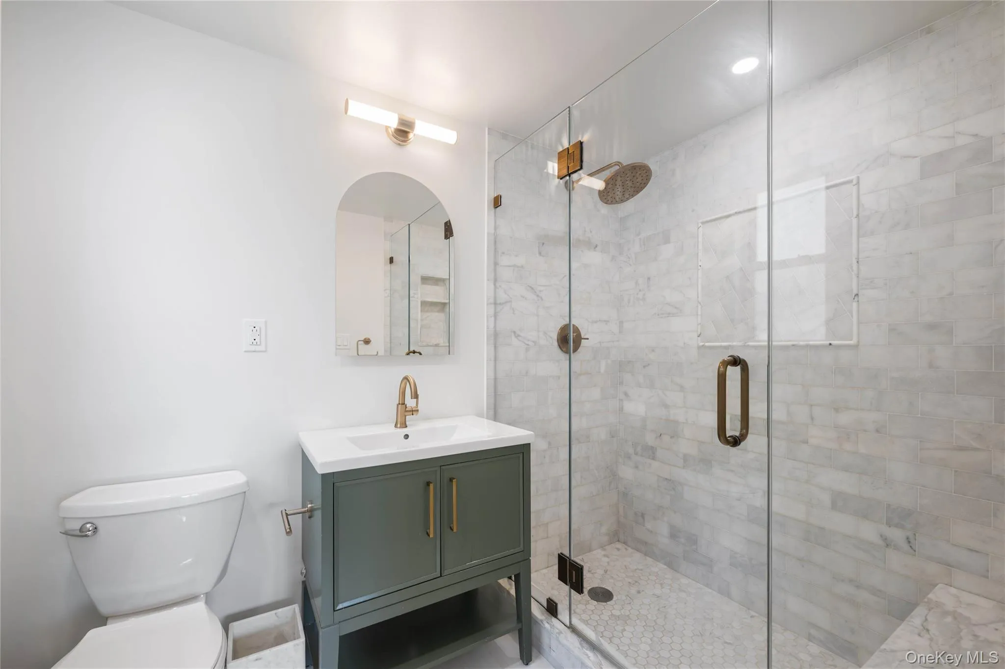 Bathroom featuring a glass-enclosed shower. Bathroom featuring a glass-enclosed shower.