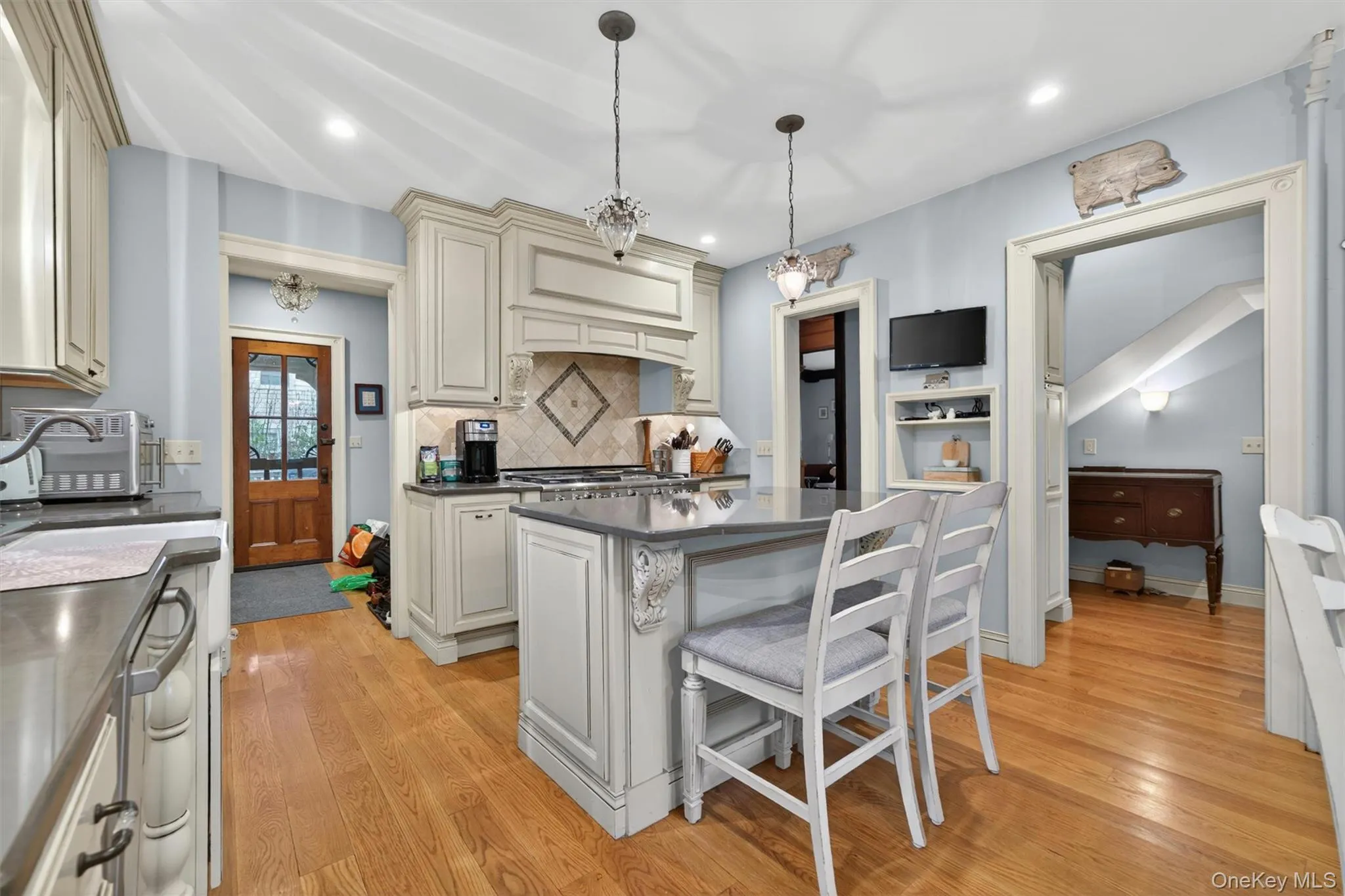 the completely remodeled chef's kitchen with quartz countertops and modern island which houses a built-in microwave and warming drawer... the completely remodeled chef's kitchen with quartz countertops and modern island which houses a built-in microwave and warming drawer...