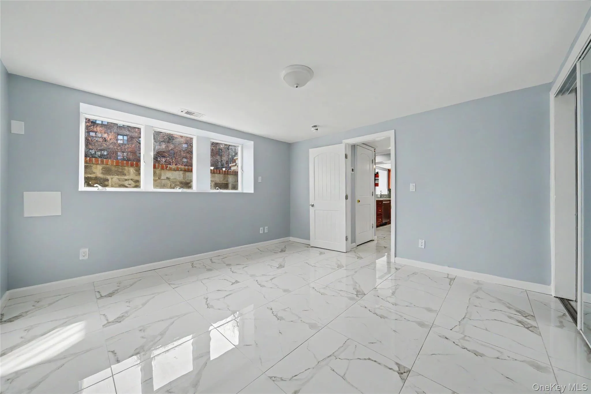 Master office space featuring a closet and light marble finish flooring Master office space featuring a closet and light marble finish flooring