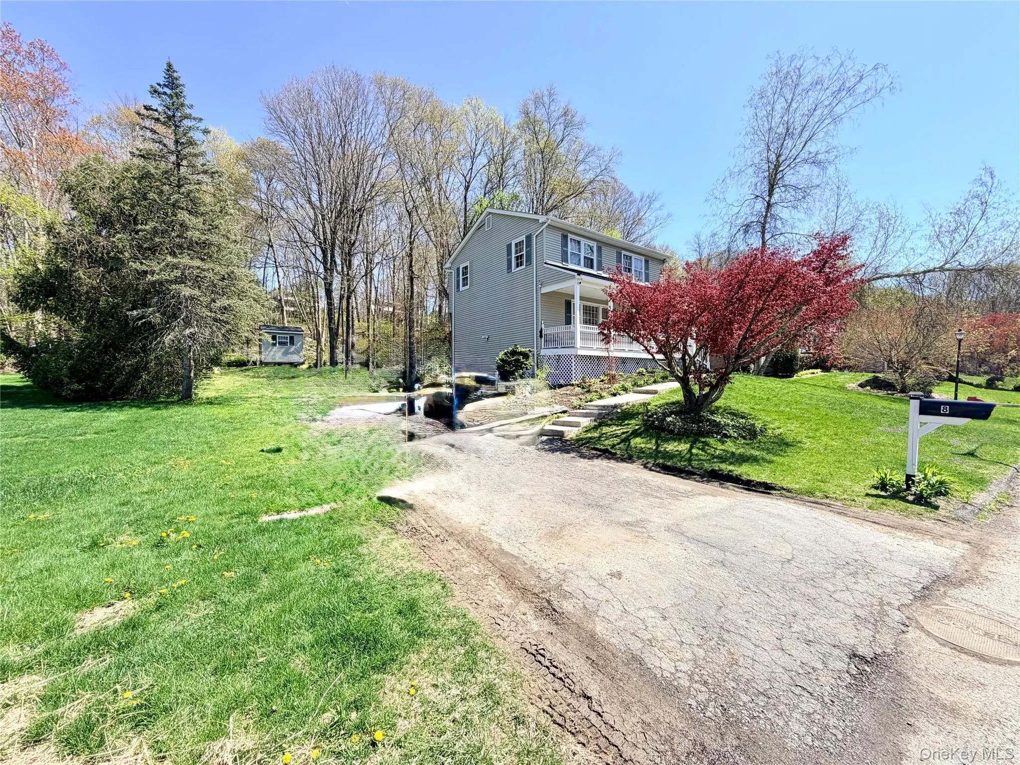Two-story residence with light gray siding and white trim Two-story residence with light gray siding and white trim