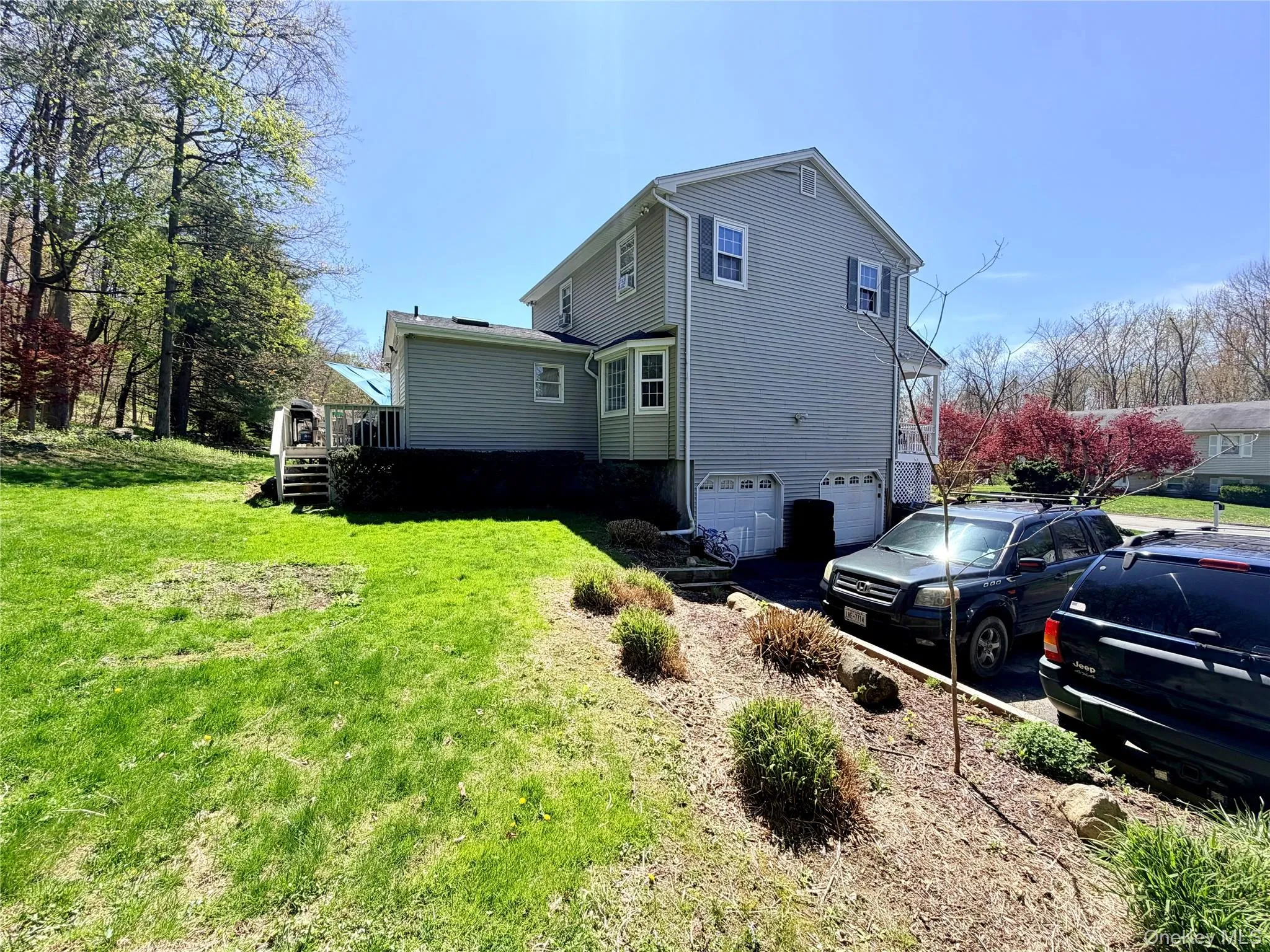 Two-story residence with light green siding and white trim Two-story residence with light green siding and white trim