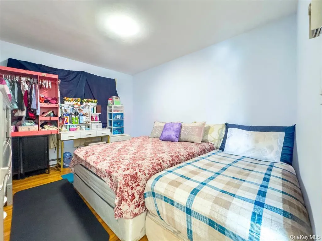 Wood-finish flooring with light blue walls and overhead lighting Wood-finish flooring with light blue walls and overhead lighting