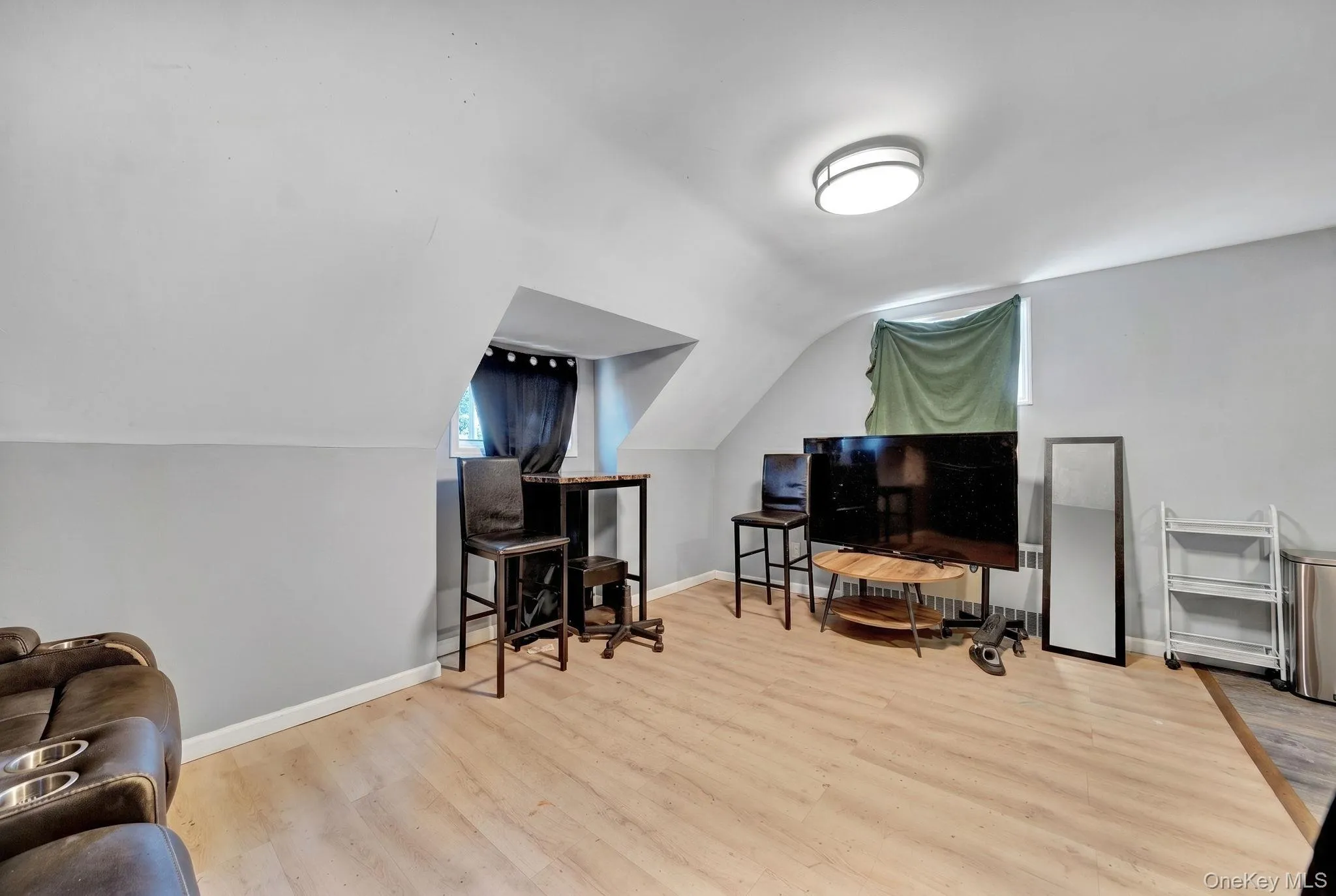 Attic space featuring wood-finish flooring and sloped ceilings 2nd floor living room Attic space featuring wood-finish flooring and sloped ceilings 2nd floor living room