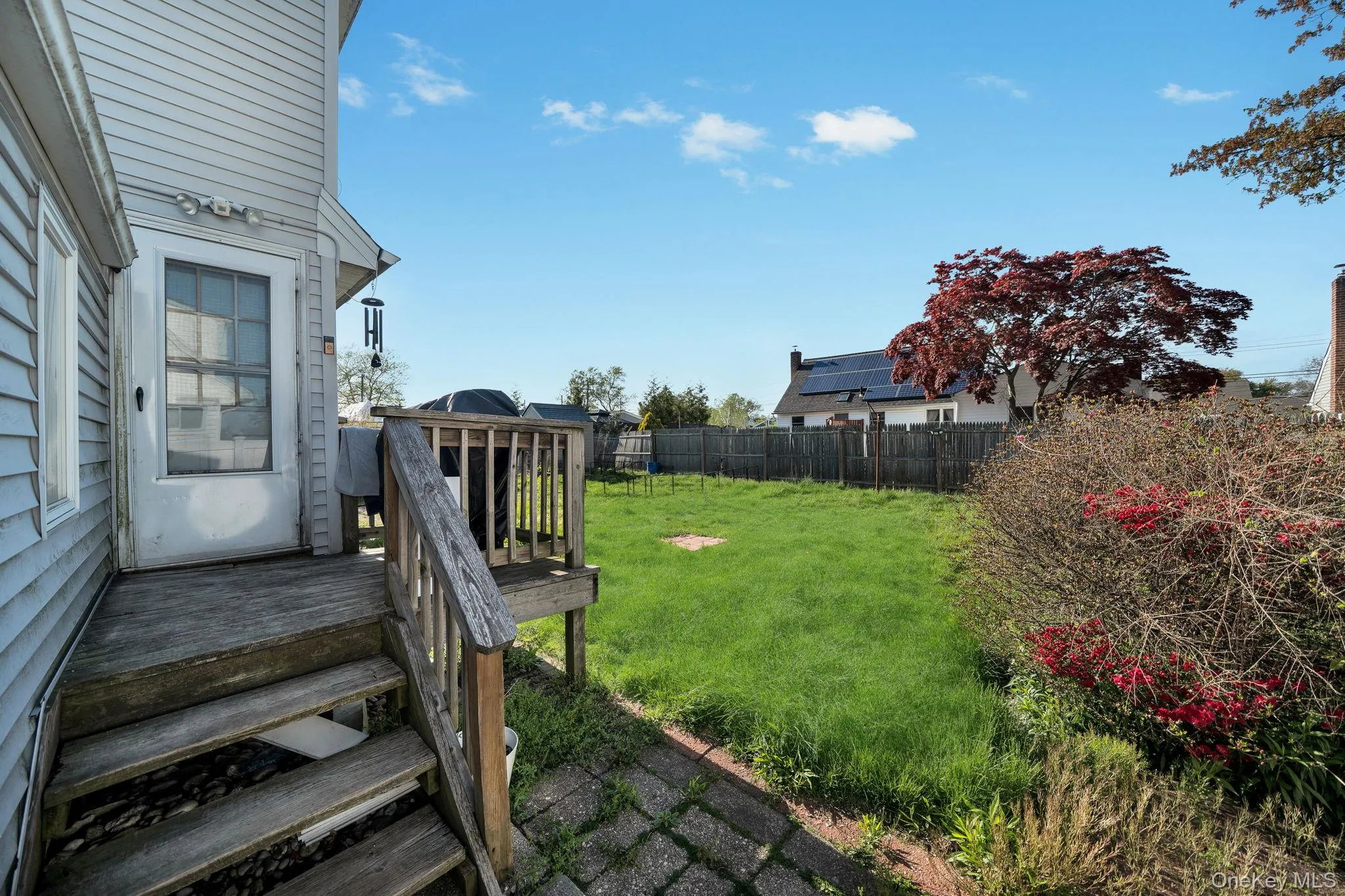Rear exterior with wood siding and a multi-level wood deck featuring a railing 1st floor back exit Rear exterior with wood siding and a multi-level wood deck featuring a railing 1st floor back exit
