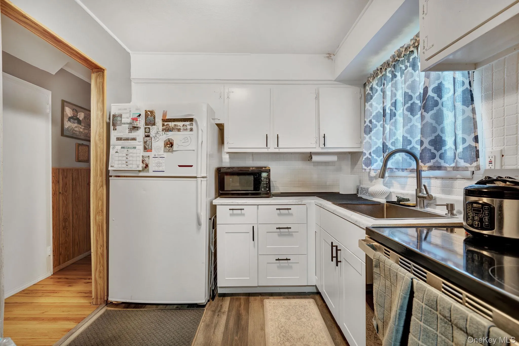 White cabinetry and black countertops define this kitchen space 1st floor White cabinetry and black countertops define this kitchen space 1st floor