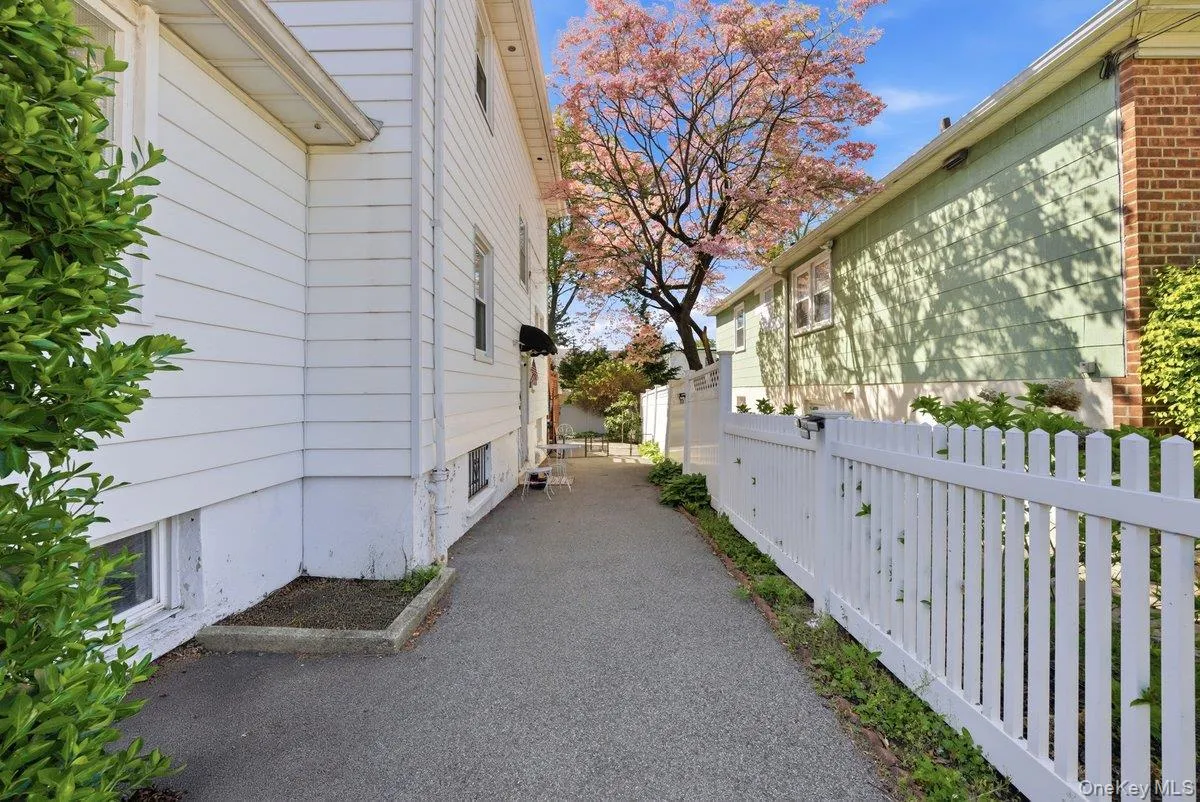 Driveway with 1 Car Garage wraps around and under the house Driveway with 1 Car Garage wraps around and under the house