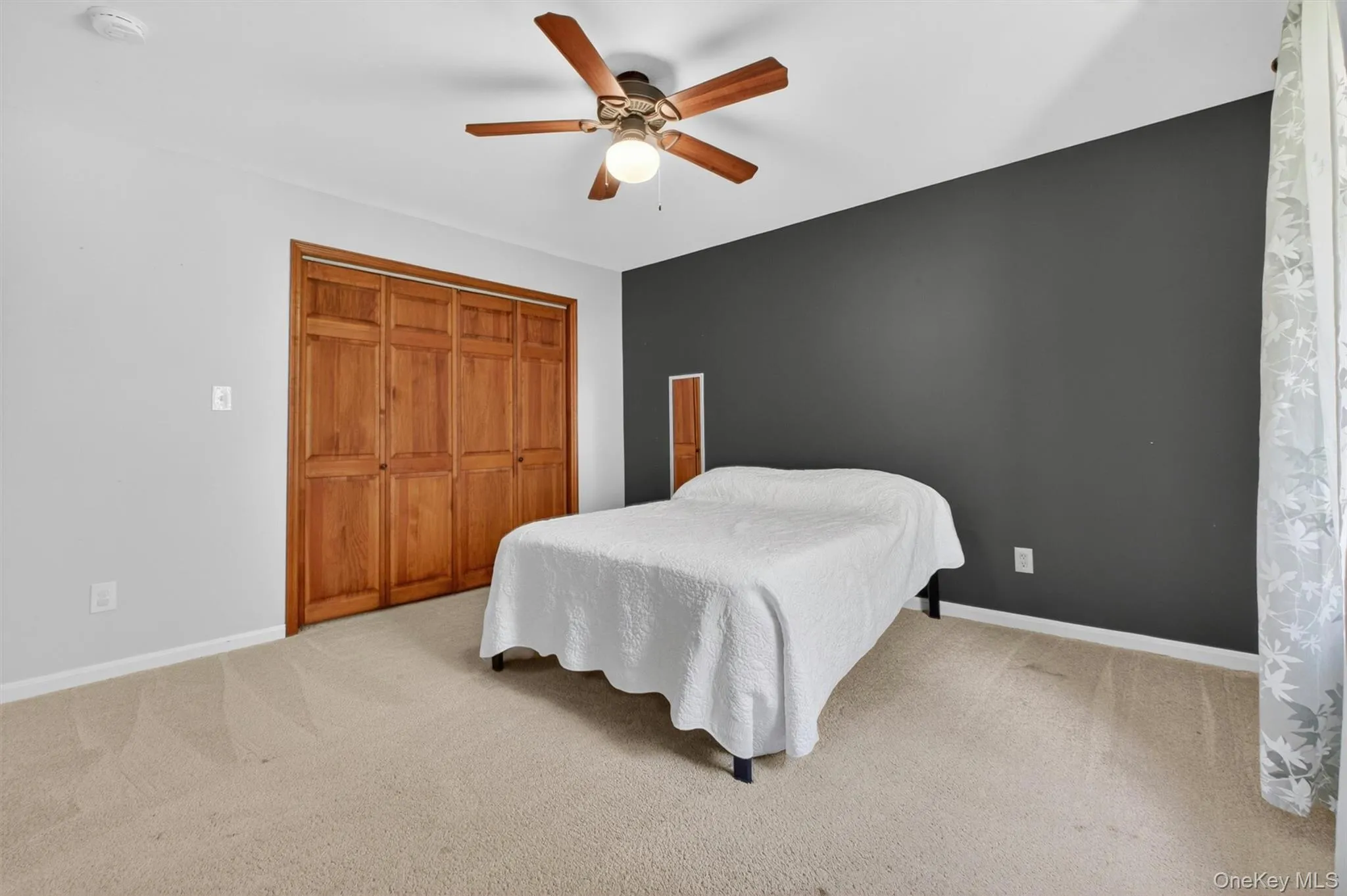 Spacious bedroom featuring large closet and carpeted floors. Spacious bedroom featuring large closet and carpeted floors.