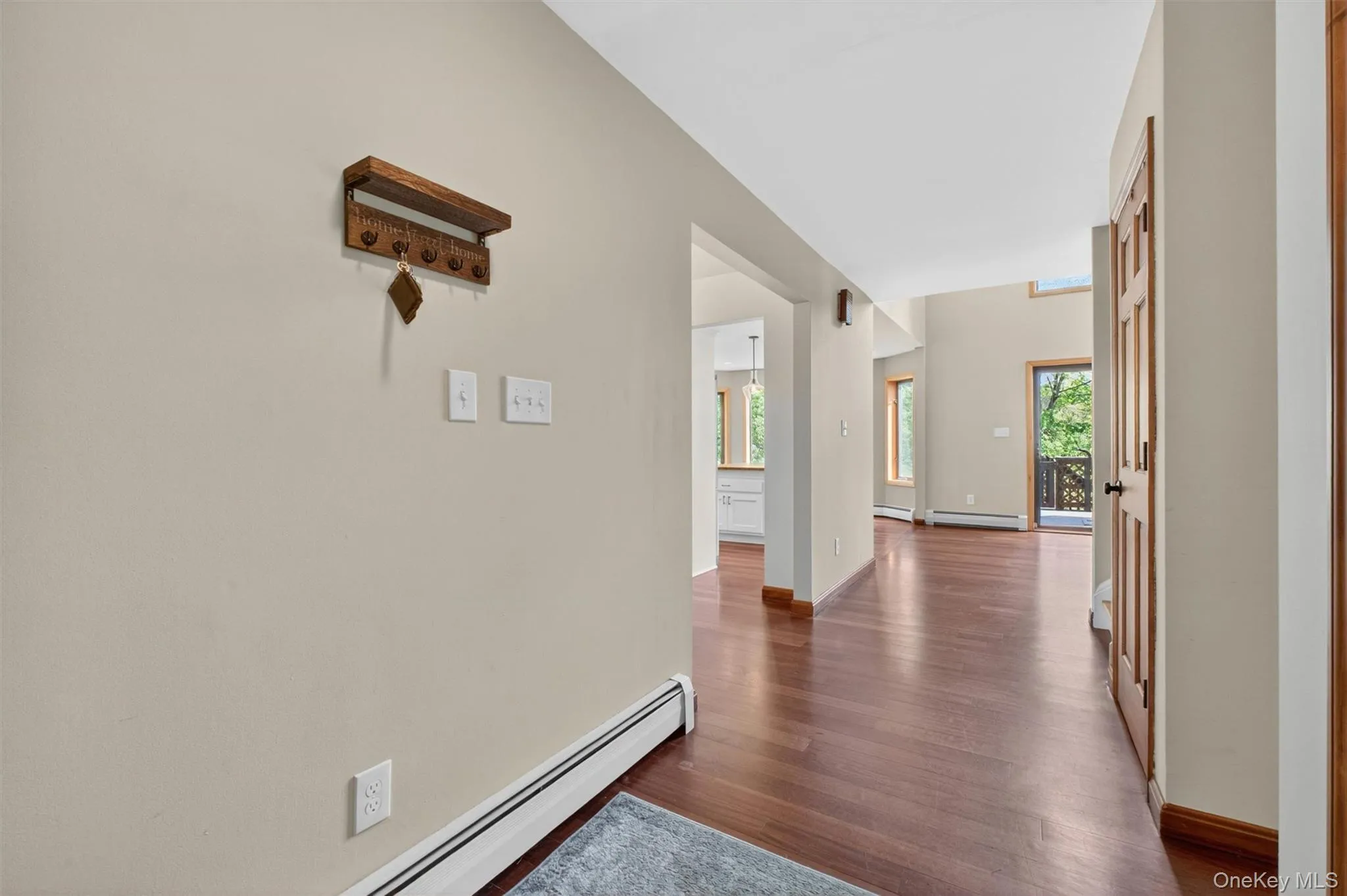 Hardwood flooring extends from the entry throughout the main living areas, complemented by neutral wall tones and white trim. Hardwood flooring extends from the entry throughout the main living areas, complemented by neutral wall tones and white trim.