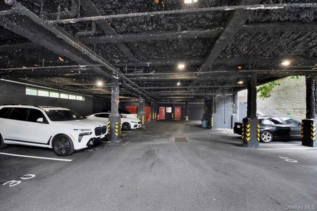 Indoor parking garage featuring multiple parking spaces Indoor parking garage featuring multiple parking spaces
