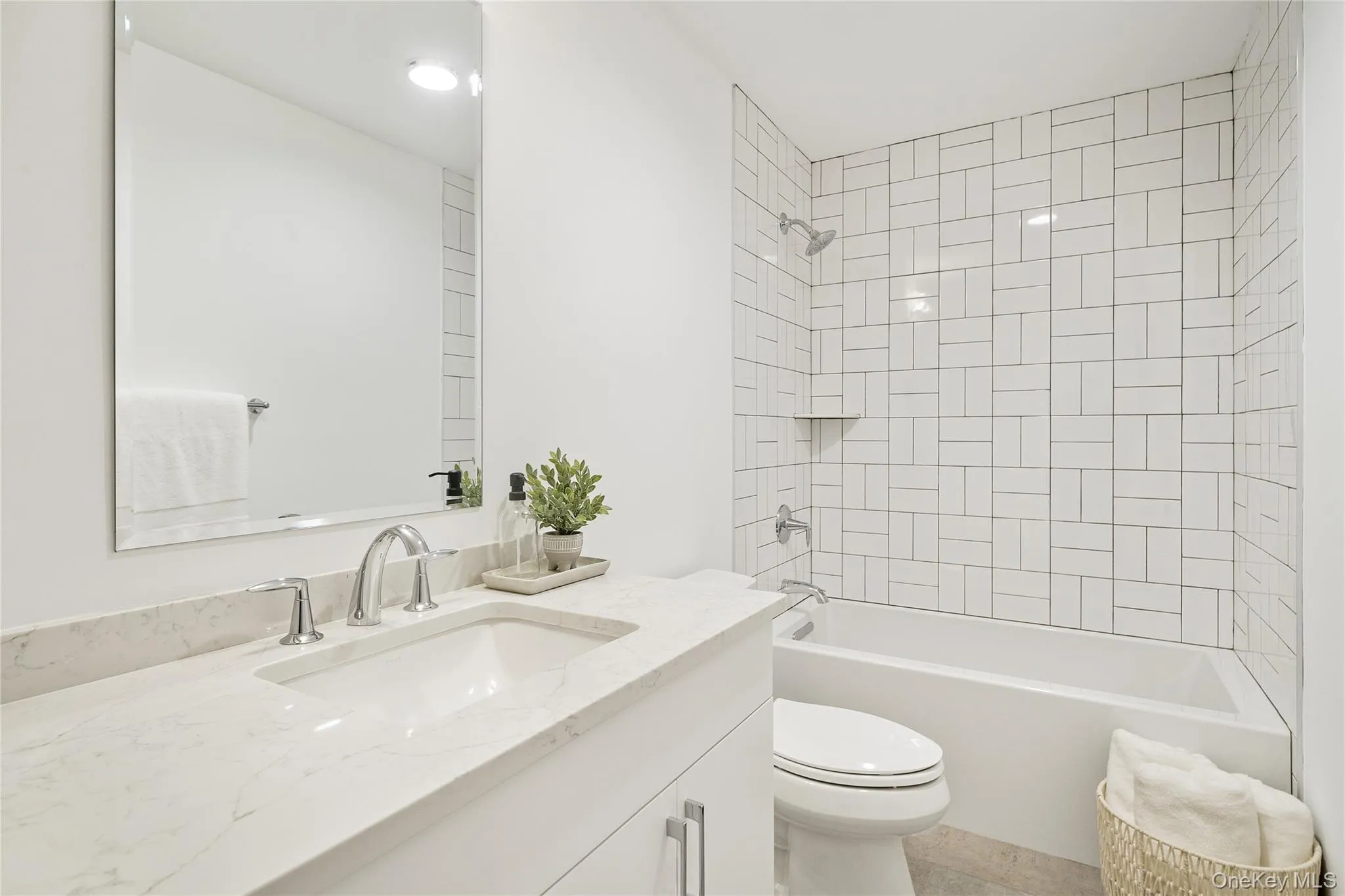 Full bathroom featuring tiled shower / bath, vanity, and toilet Full bathroom featuring tiled shower / bath, vanity, and toilet