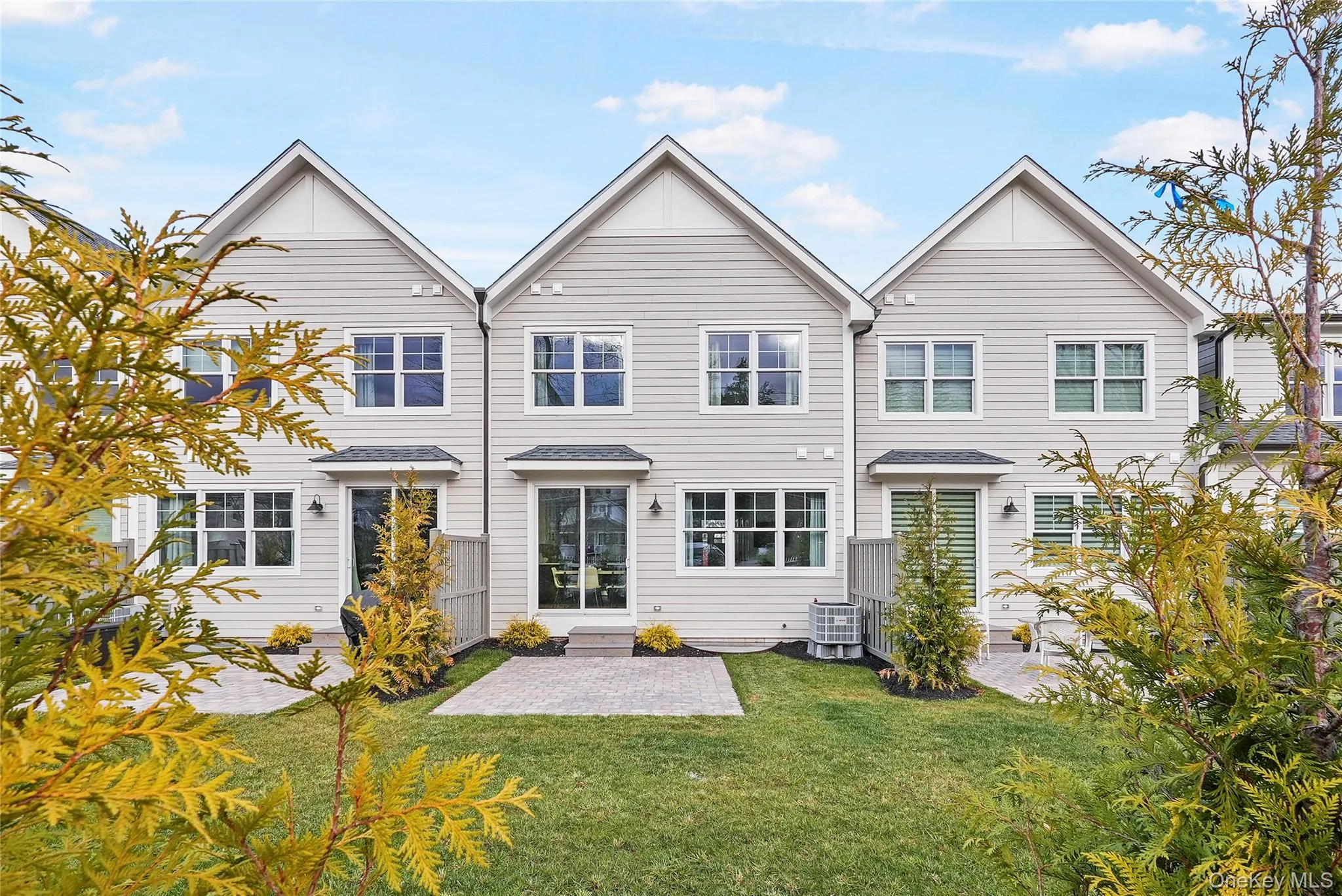 Rear view of property featuring central AC, a patio, and a lawn Rear view of property featuring central AC, a patio, and a lawn