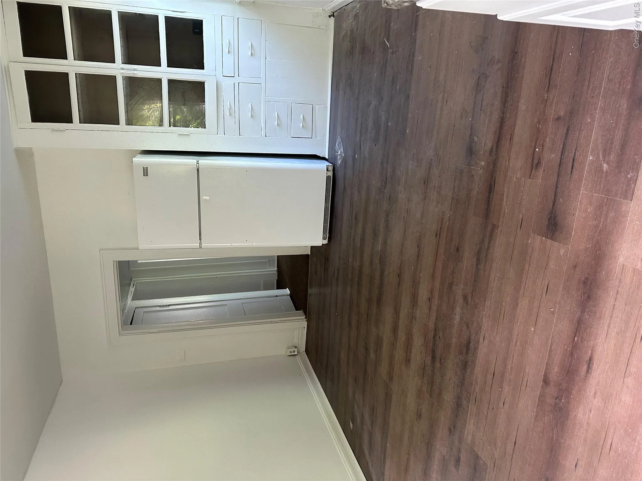 Unfurnished room with dark hardwood / wood-style floors Unfurnished room with dark hardwood / wood-style floors