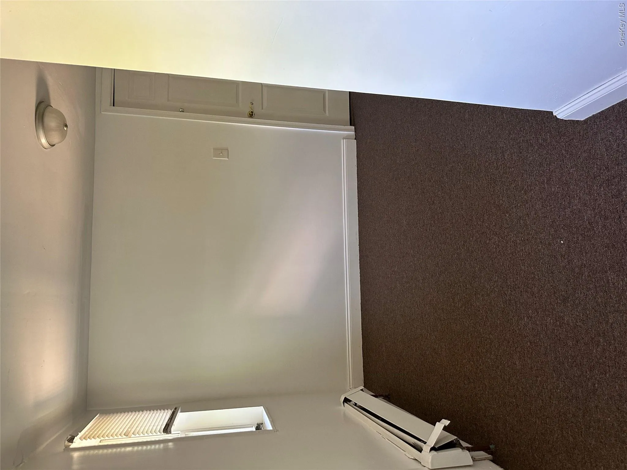 Carpeted empty room with baseboard heating Carpeted empty room with baseboard heating