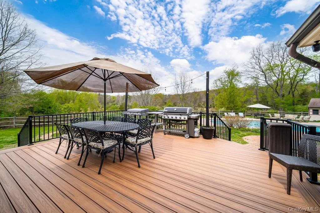 This composite deck is conveniently located right off of the kitchen overlooking the pool! A great entertainment flow or outdoor spot for a lovely evening dinner. This composite deck is conveniently located right off of the kitchen overlooking the pool! A great entertainment flow or outdoor spot for a lovely evening dinner.