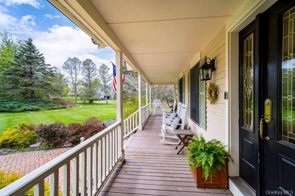 This lovely wrap-around over-sized porch welcomes you home and overlooks the spacious front yard. This lovely wrap-around over-sized porch welcomes you home and overlooks the spacious front yard.