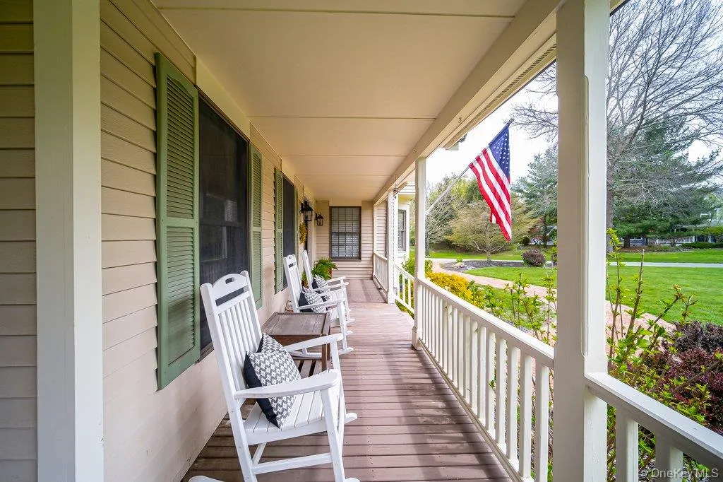This lovely wrap-around over-sized porch welcomes you home and overlooks the spacious front yard. This lovely wrap-around over-sized porch welcomes you home and overlooks the spacious front yard.