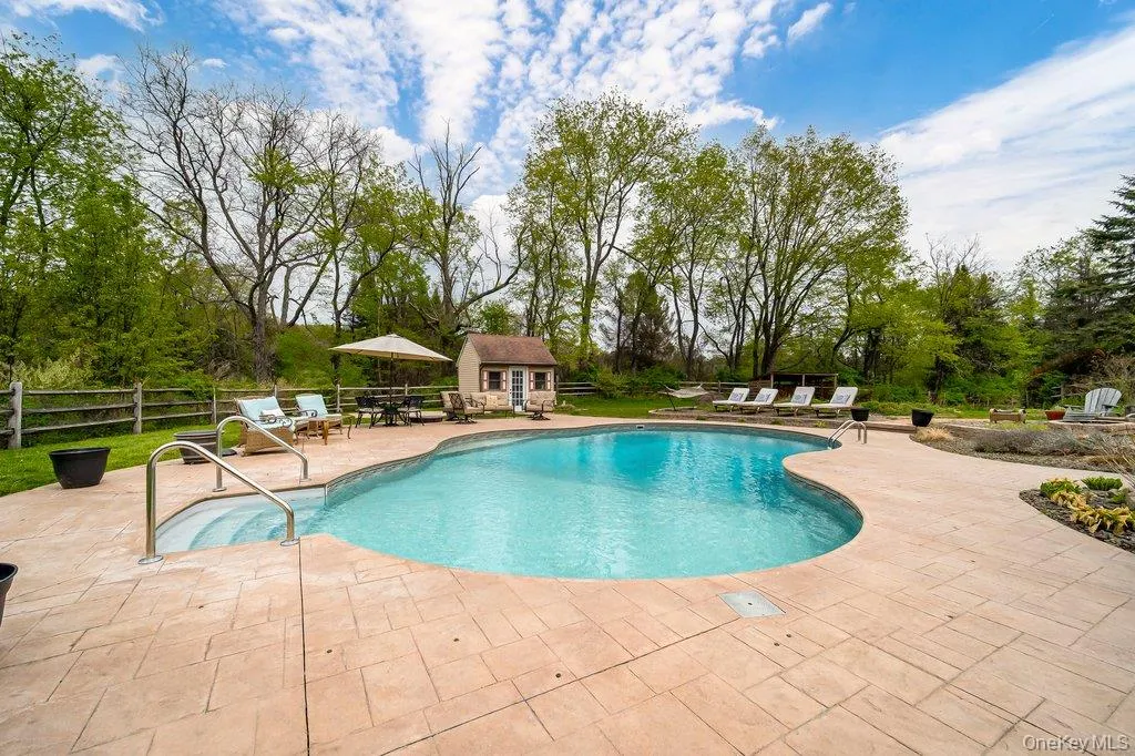 Gorgeous custom salt-water inground pool with pool house and patio decking. Gorgeous custom salt-water inground pool with pool house and patio decking.