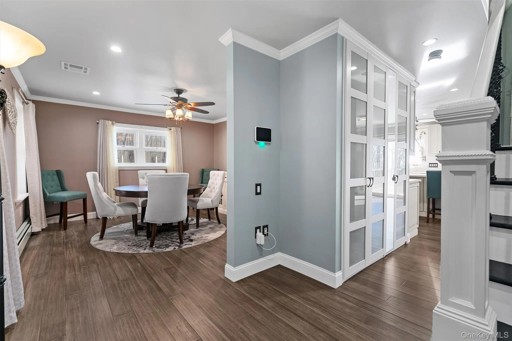 With view of the custom hall closets and dining room. Featuring the custom bamboo flooring. With view of the custom hall closets and dining room. Featuring the custom bamboo flooring.