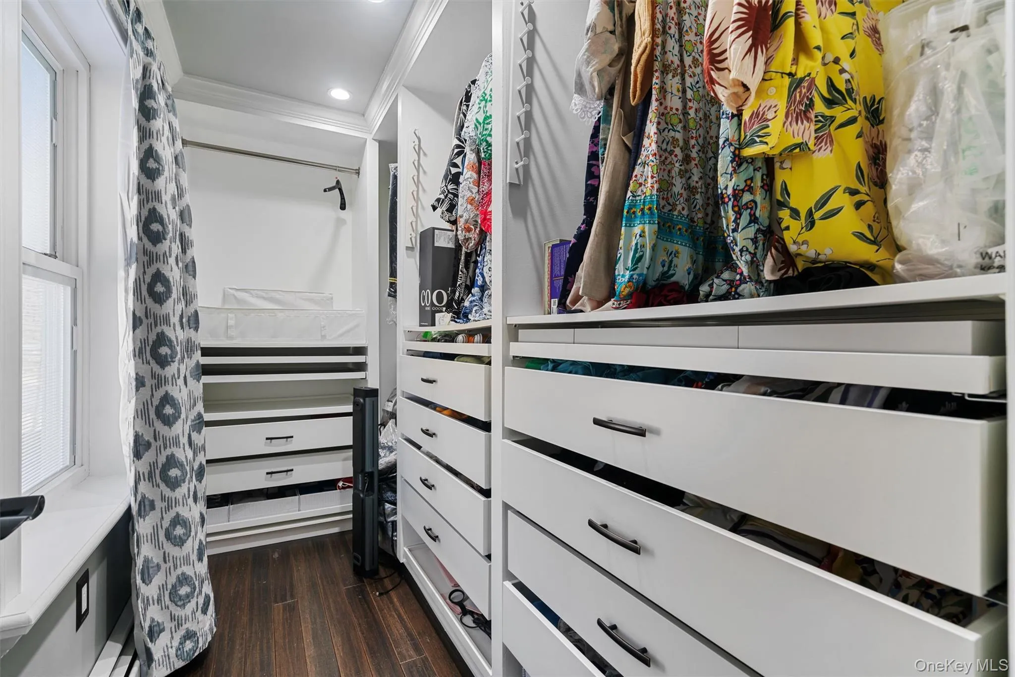 Custom primary closet with organized storage. Custom primary closet with organized storage.