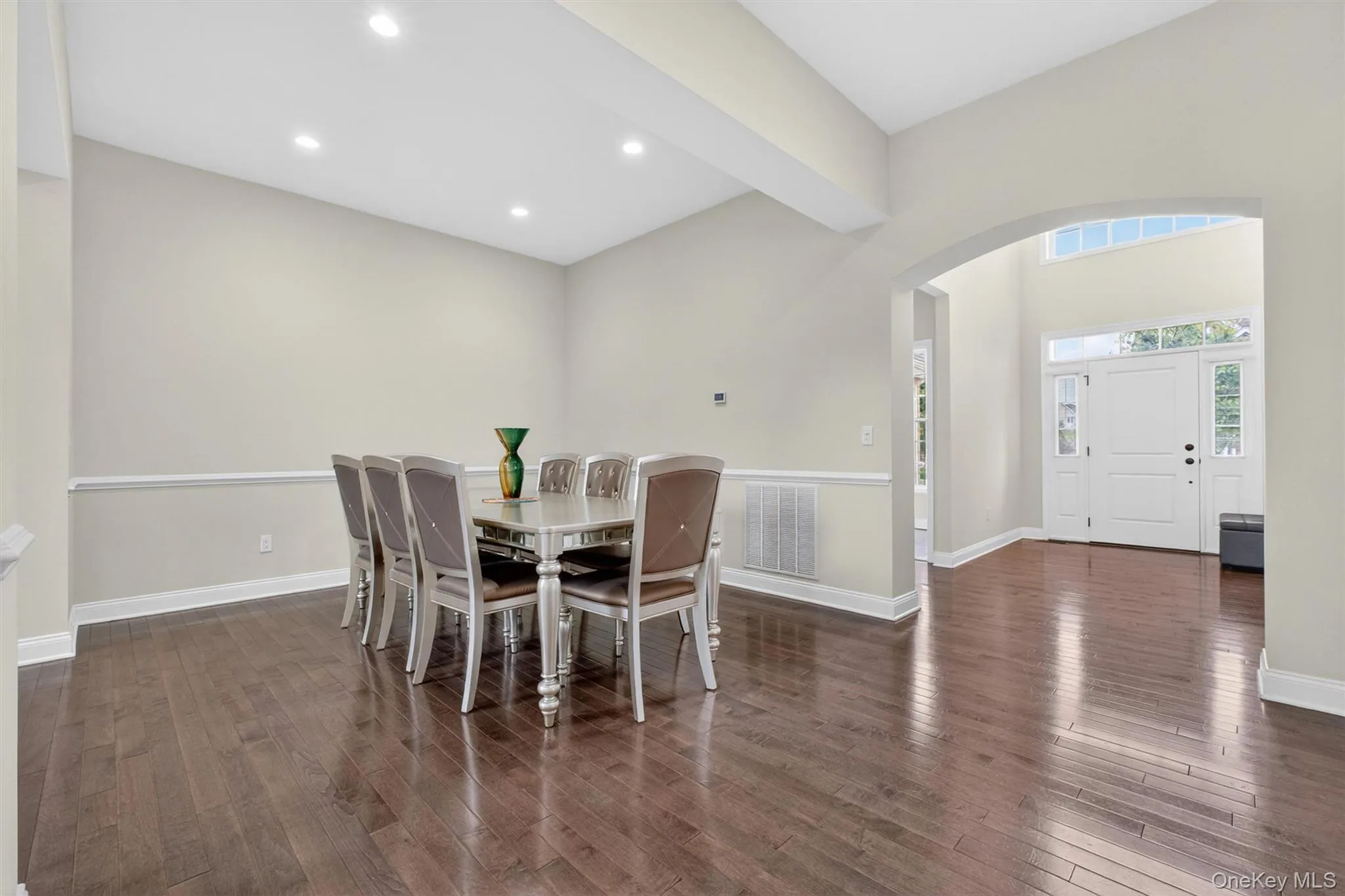 Formal dining area featuring rich grey wood flooring, recessed lighting, and crown molding Formal dining area featuring rich grey wood flooring, recessed lighting, and crown molding