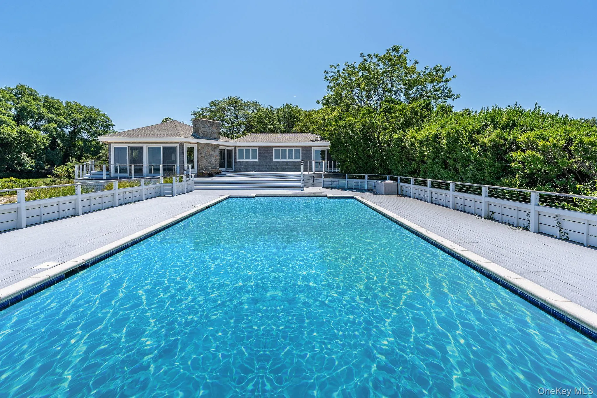 View of swimming pool with a patio and view of scattered trees View of swimming pool with a patio and view of scattered trees