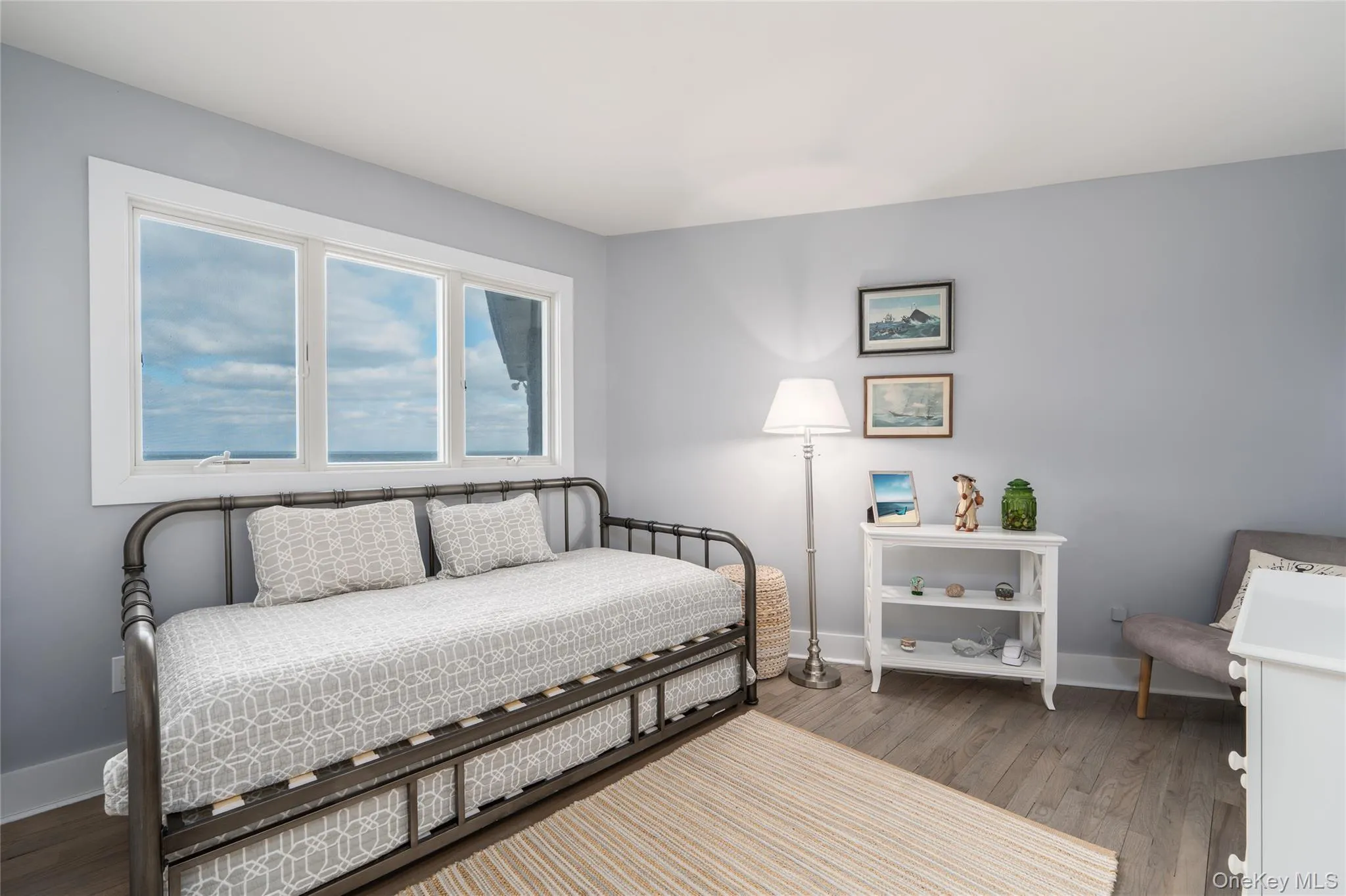 Bedroom featuring baseboards and wood finished floors Bedroom featuring baseboards and wood finished floors