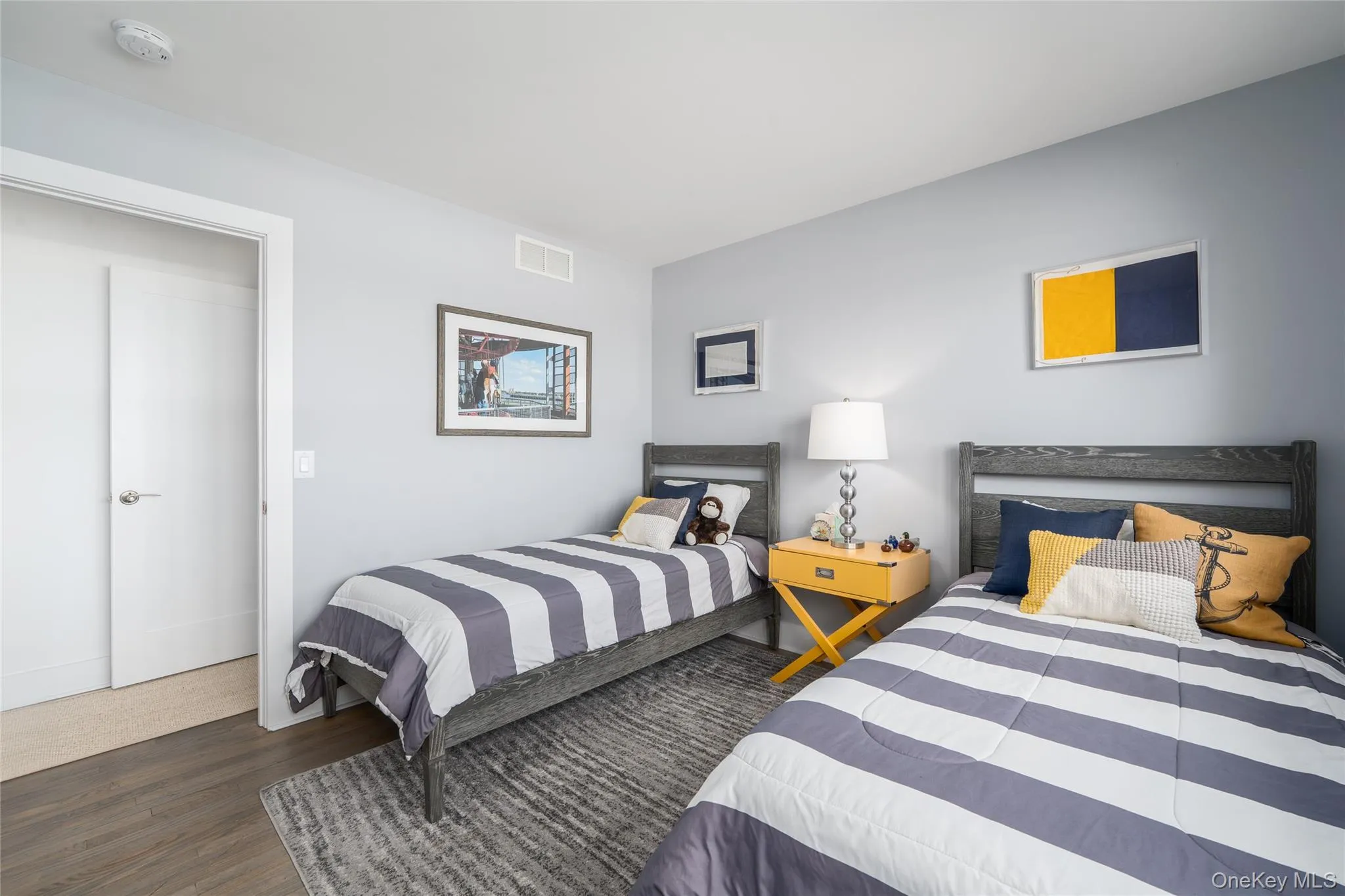 Bedroom featuring visible vents and wood finished floors Bedroom featuring visible vents and wood finished floors