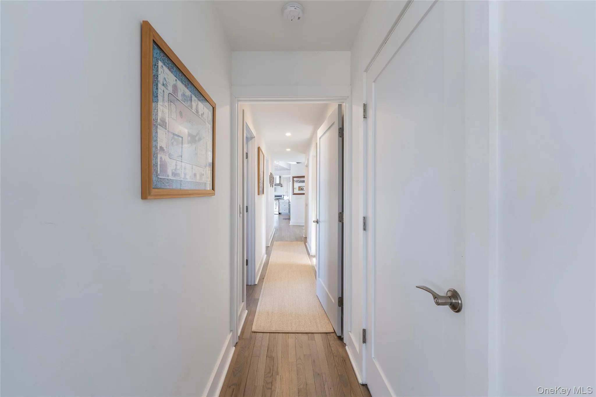 Corridor with baseboards and wood finished floors Corridor with baseboards and wood finished floors