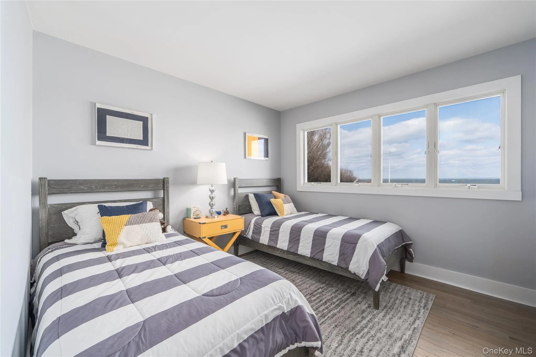 Bedroom featuring baseboards and wood finished floors Bedroom featuring baseboards and wood finished floors