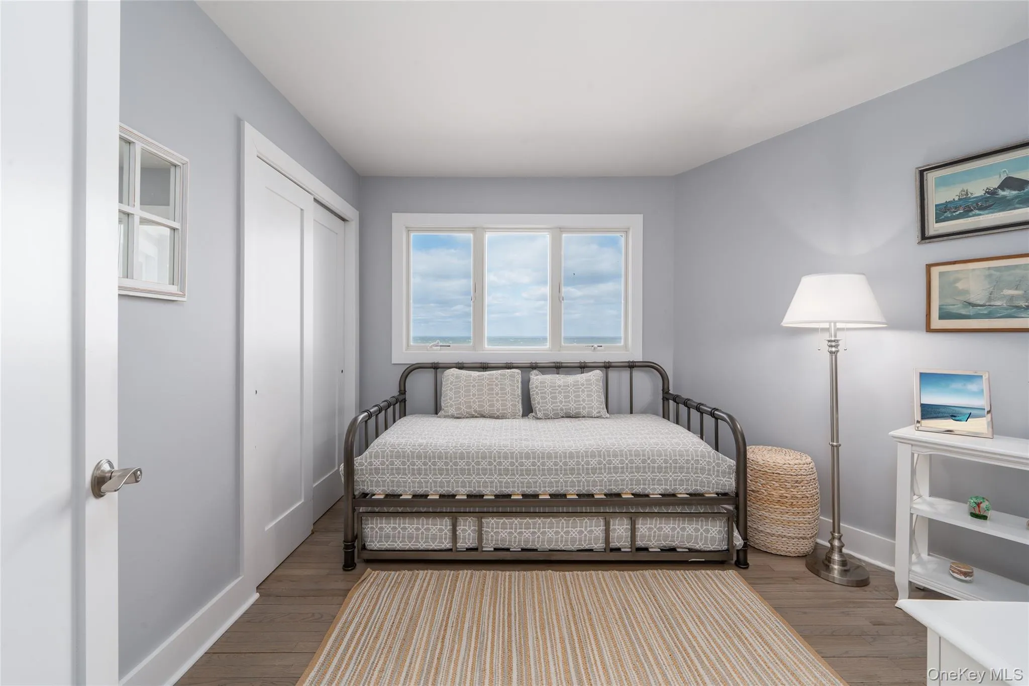 Bedroom with baseboards, wood finished floors, and a closet Bedroom with baseboards, wood finished floors, and a closet