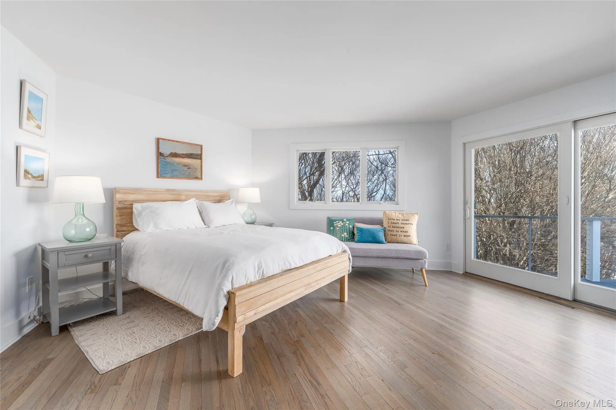 Bedroom featuring baseboards, access to exterior, and wood finished floors Bedroom featuring baseboards, access to exterior, and wood finished floors